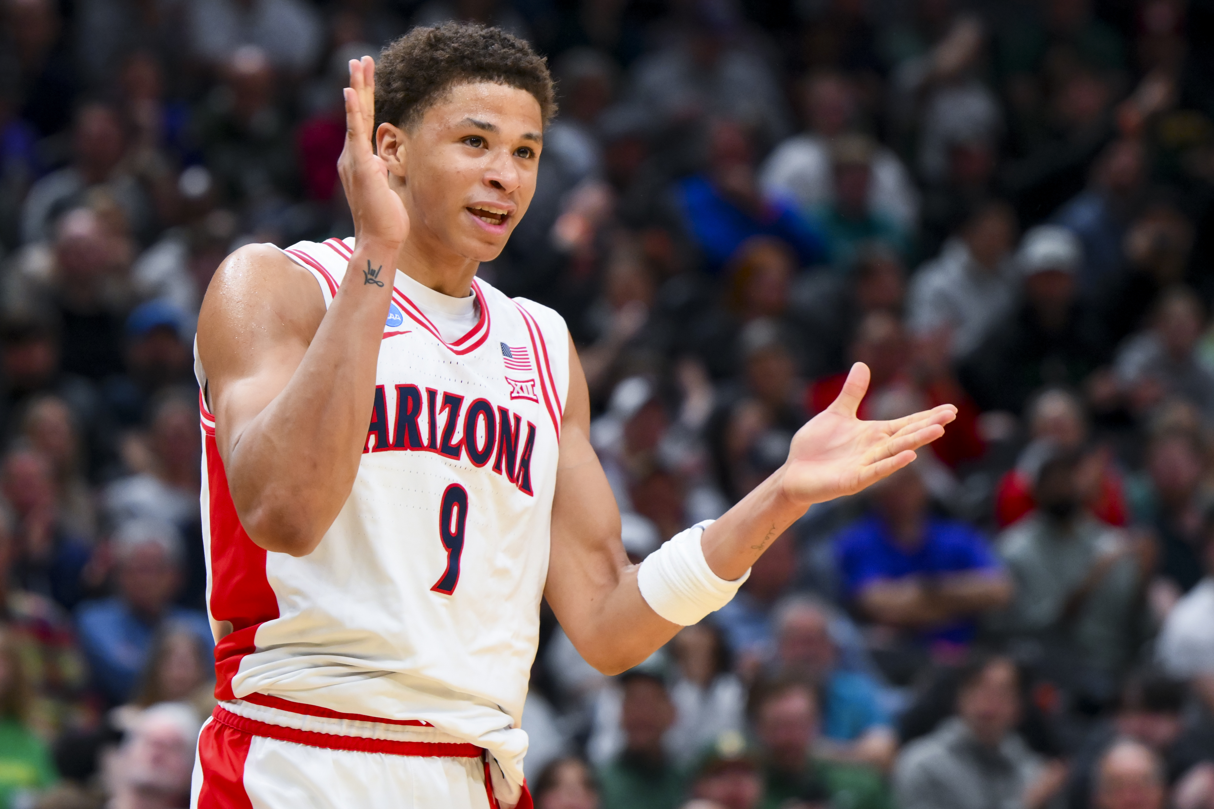 Mar 23, 2025; Seattle, WA, USA; Arizona Wildcats forward Carter Bryant (9) reacts against the Oregon Ducks in the first half at Climate Pledge Arena. Mandatory Credit: Steven Bisig-Imagn Images  