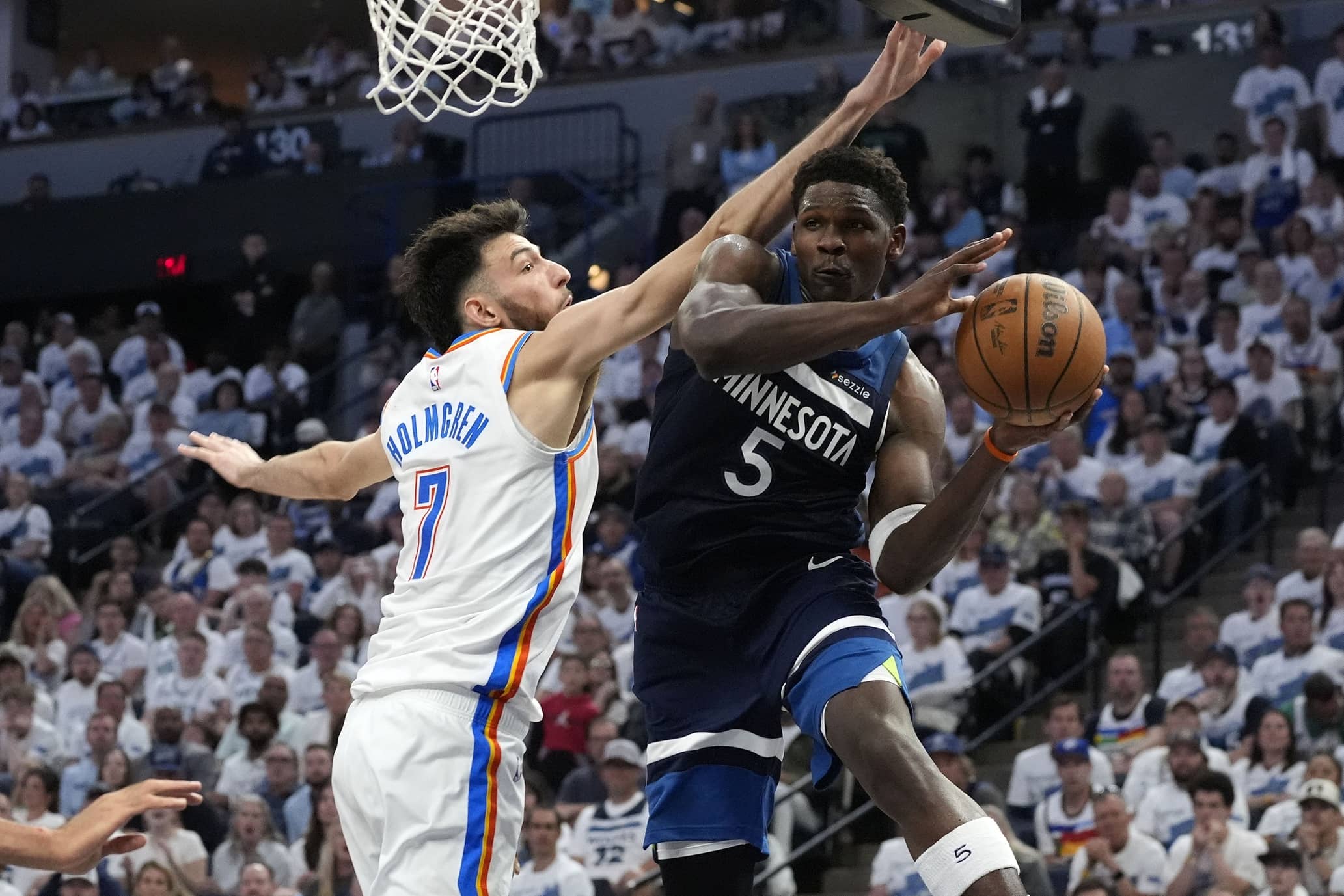 May 26, 2025; Minneapolis, Minnesota, USA; Minnesota Timberwolves guard Anthony Edwards (5) makes a pass against Oklahoma City Thunder forward Chet Holmgren (7) in the second half during game four of the Western Conference Finals for the 2025 NBA Playoffs at Target Center. Mandatory Credit: Bruce Kluckhohn-Imagn Images
