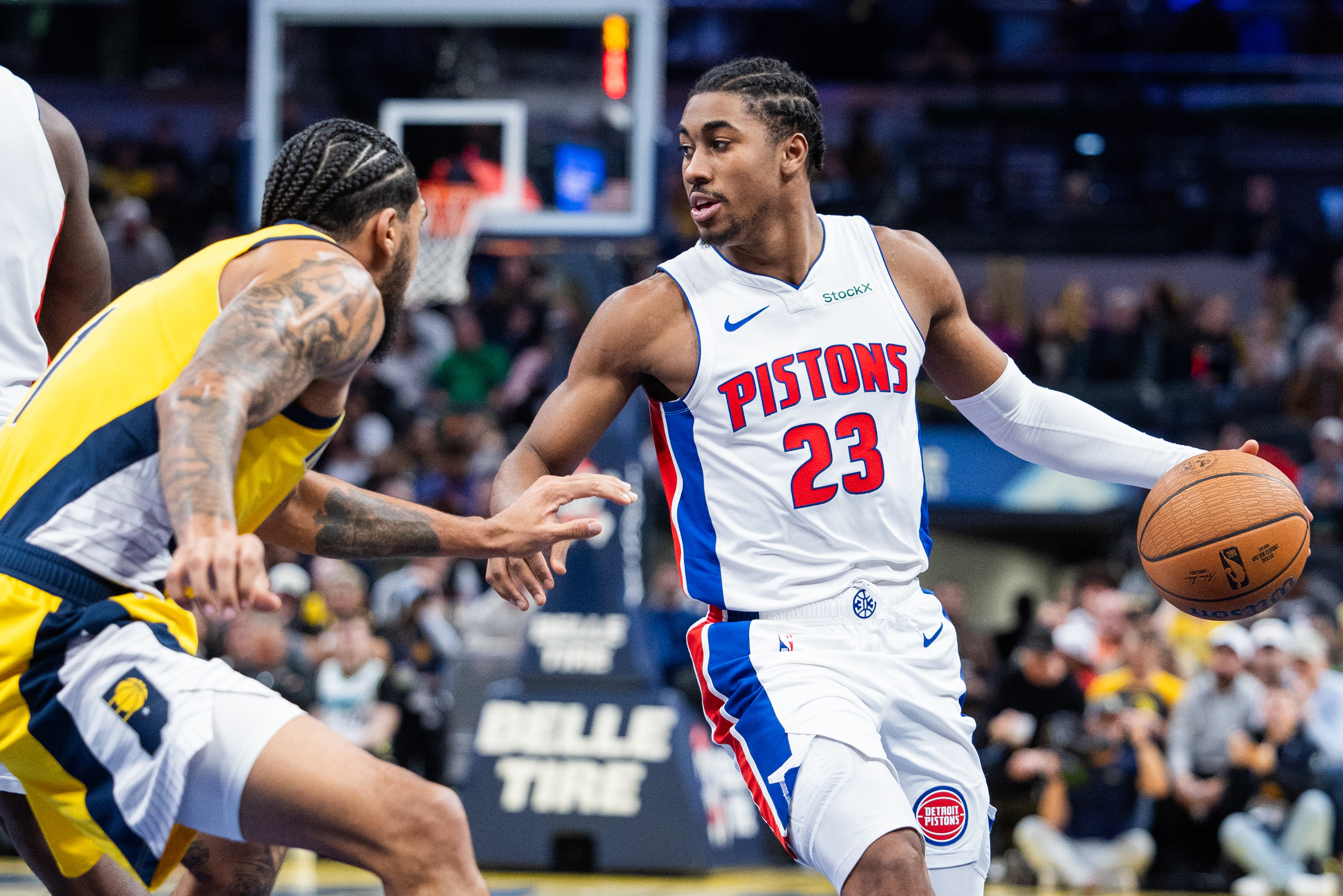 Nov 29, 2024; Indianapolis, Indiana, USA; Detroit Pistons guard Jaden Ivey (23) dribbles the ball while Indiana Pacers forward Obi Toppin (1) defends in the second half at Gainbridge Fieldhouse. Mandatory Credit: Trevor Ruszkowski-Imagn Images  