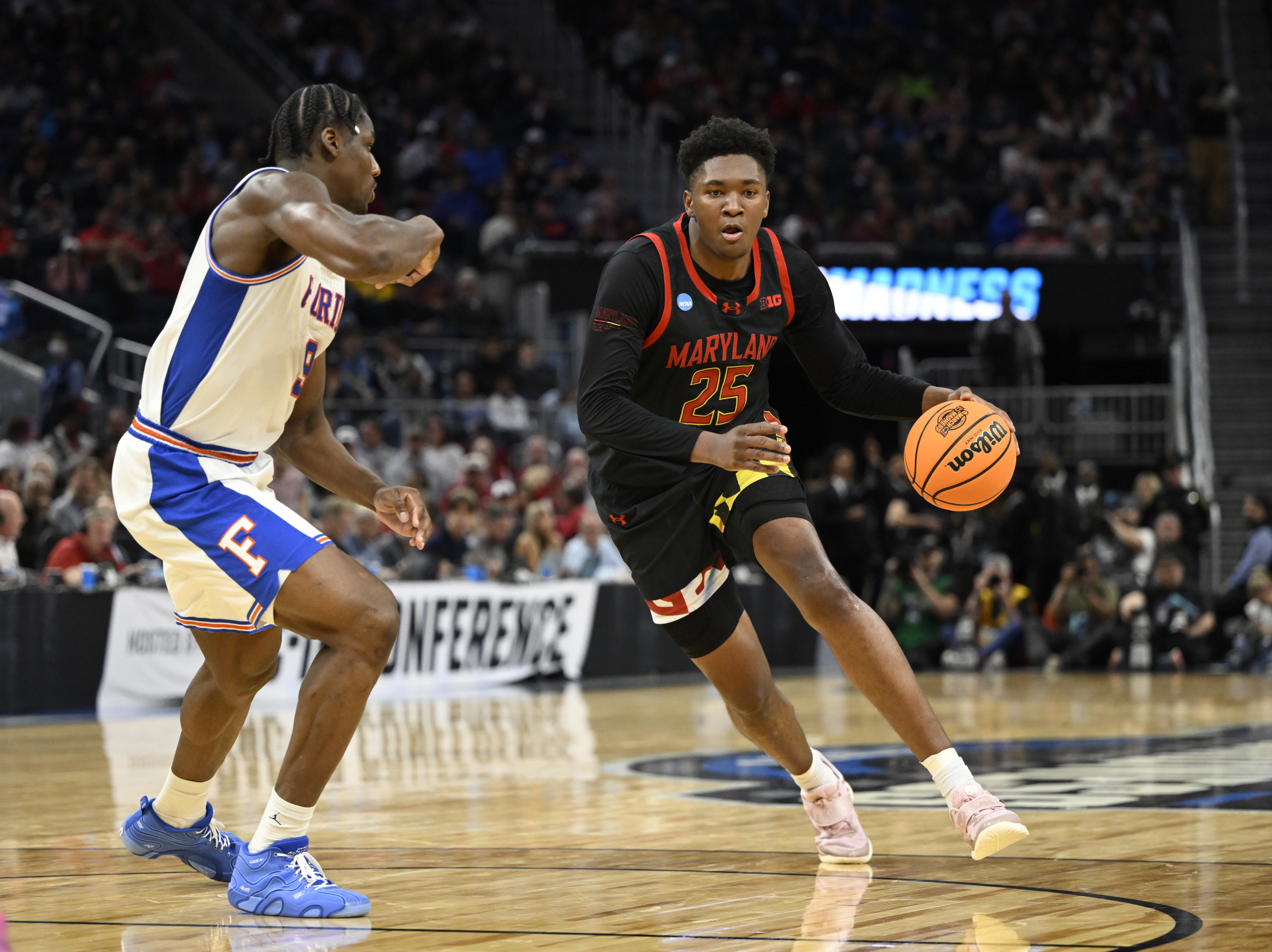 Mar 27, 2025; San Francisco, CA, USA; Maryland Terrapins center Derik Queen (25) dribbles down court past Florida Gators center Rueben Chinyelu (9) during the second half during a West Regional semifinal of the 2025 NCAA tournament at Chase Center. Mandatory Credit: Eakin Howard-Imagn Images  
