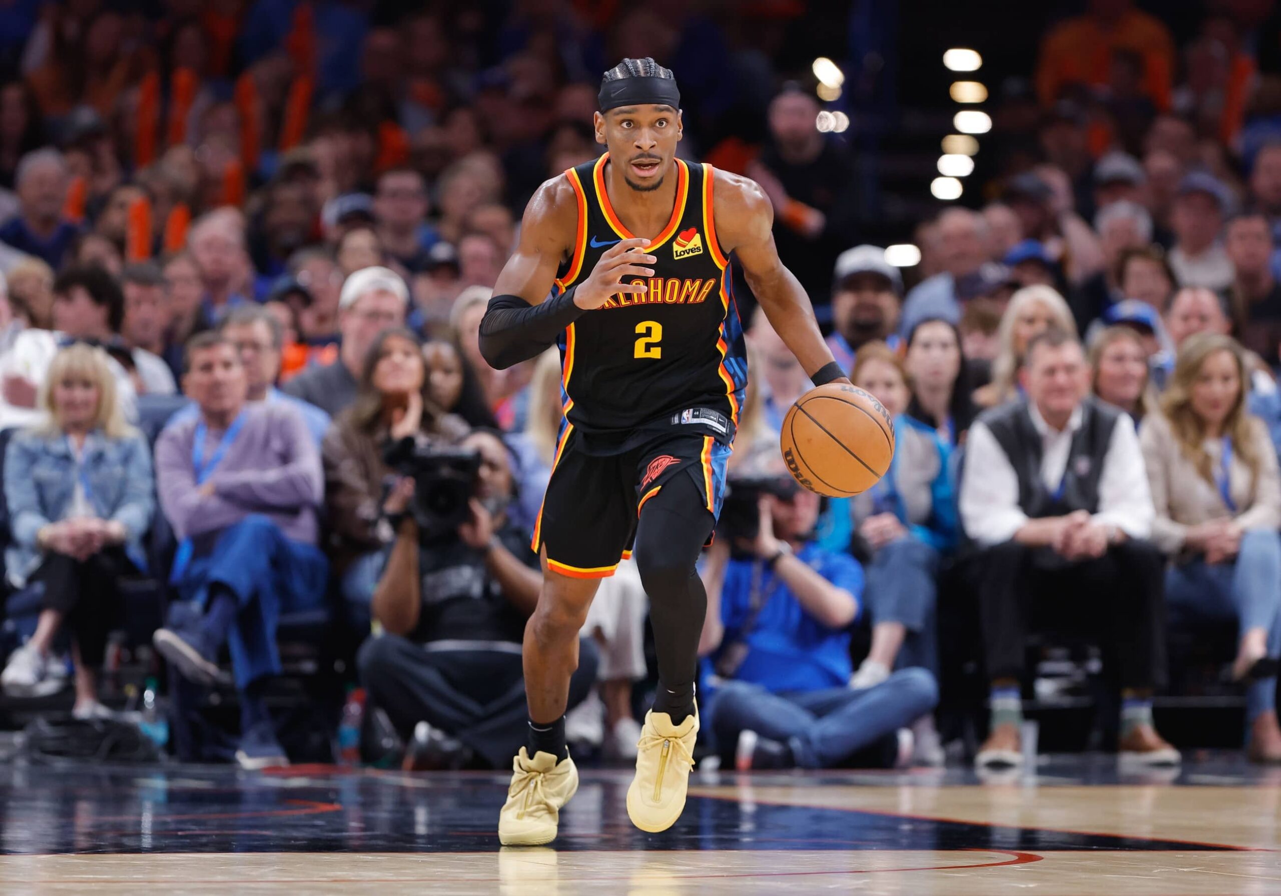 Shai Gilgeous-Alexander dribbles the ball during a game between the Oklahoma City Thunder and Denver Nuggets.