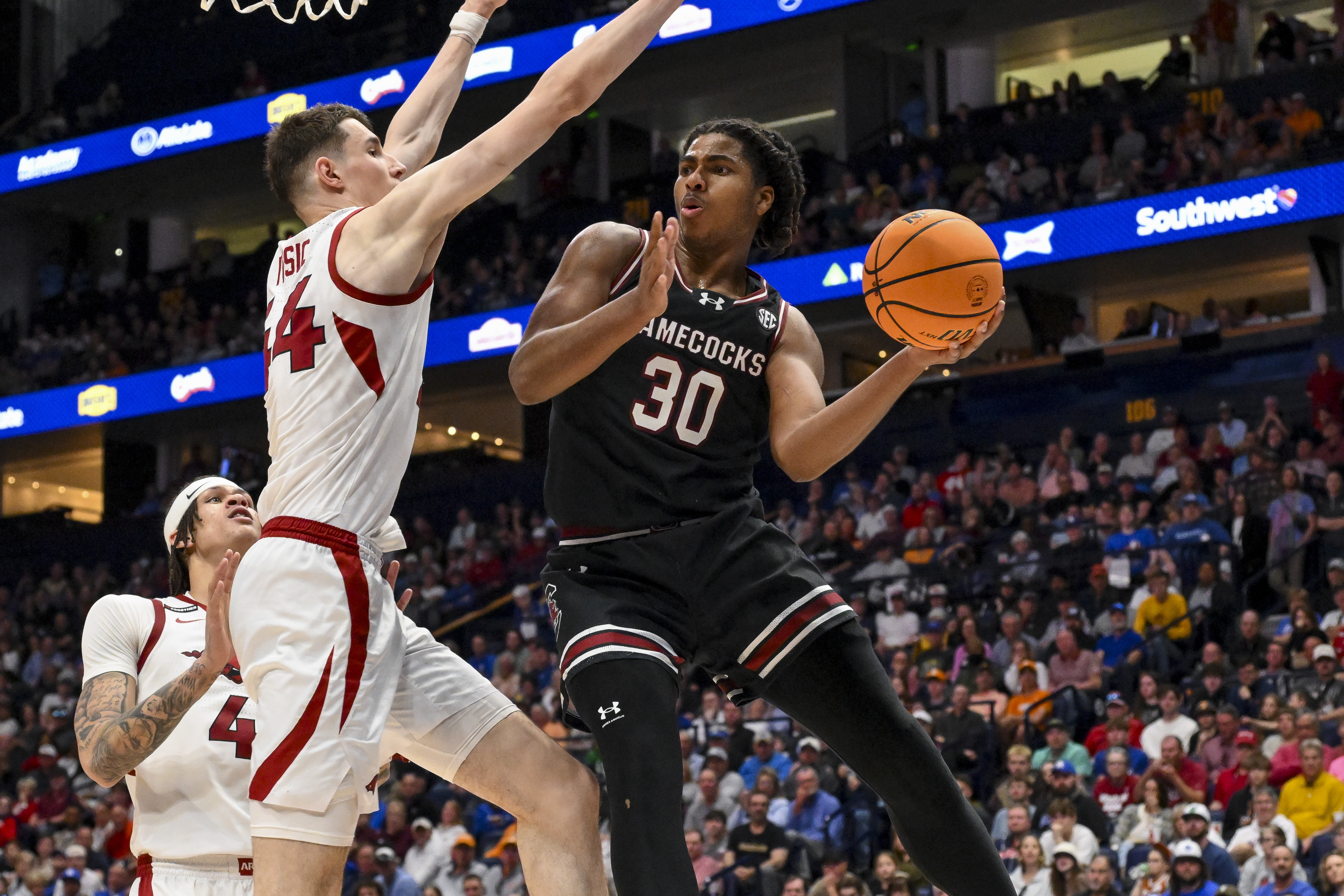 Mar 12, 2025; Nashville, TN, USA; South Carolina Gamecocks forward Collin Murray-Boyles (30) passes the ball under the arms of Arkansas Razorbacks forward Zvonimir Ivisic (44) during the second half at Bridgestone Arena. Mandatory Credit: Steve Roberts-Imagn Images  