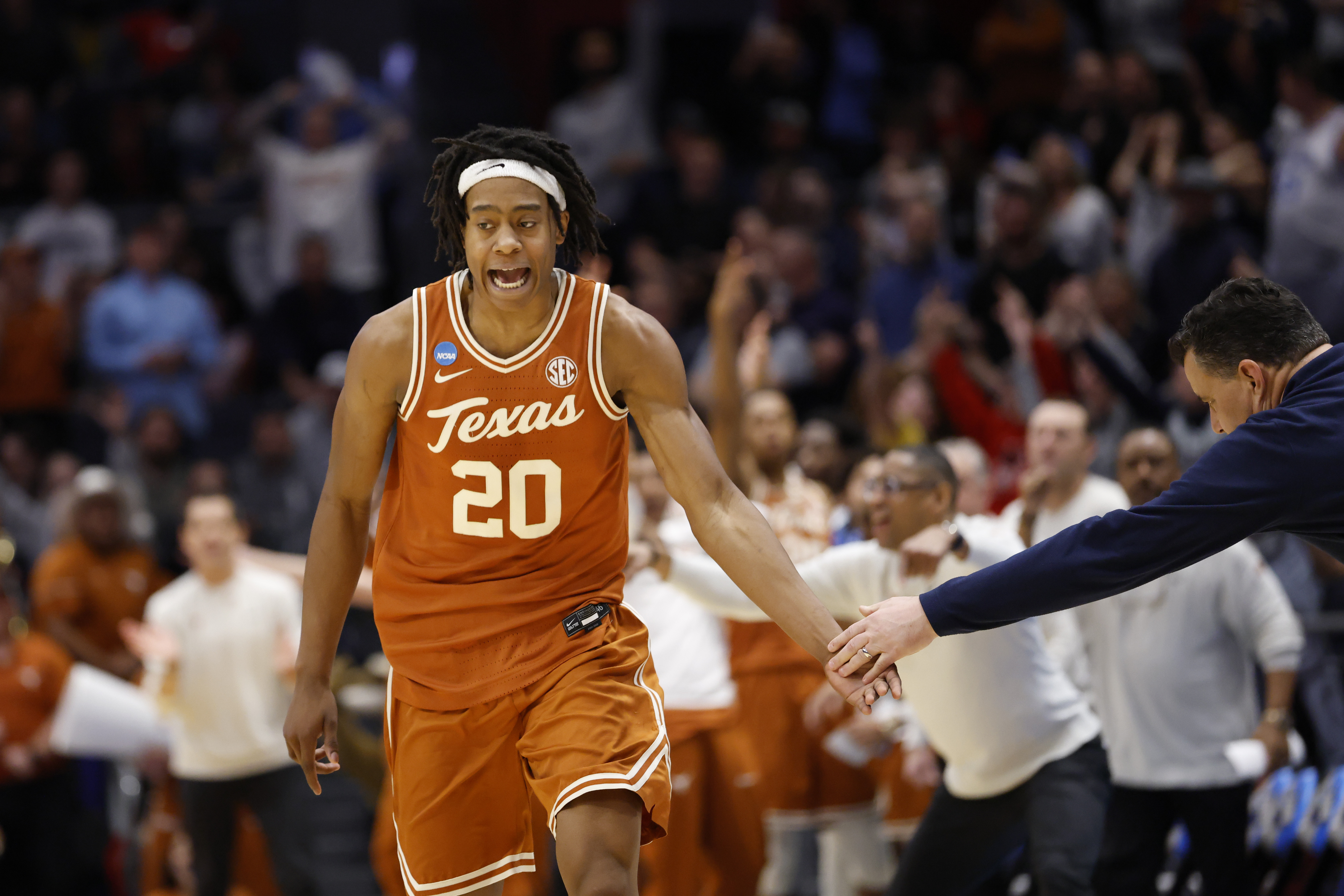 Mar 19, 2025; Dayton, OH, USA; Texas Longhorns guard Tre Johnson (20) high fives Xavier Musketeers head coach Sean Miller after making a three point basket in the second half at UD Arena. Mandatory Credit: Rick Osentoski-Imagn Images  