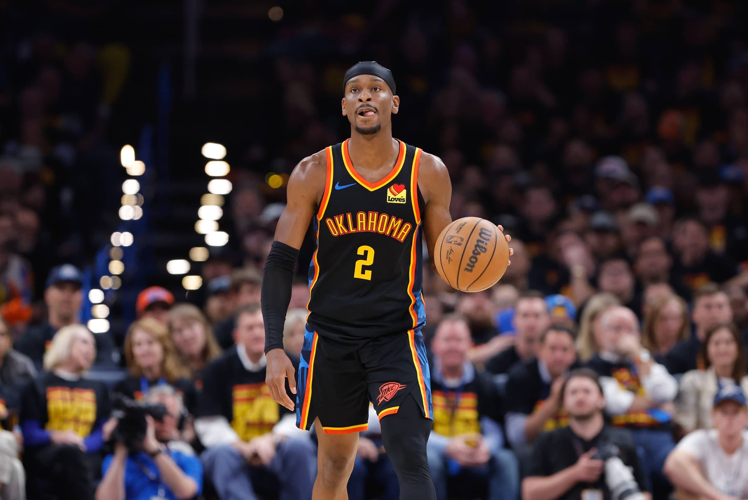 Thunder guard Shai Gilgeous-Alexander dribbles down the court against the Nuggets during the second half during game one of the second round for the 2025 NBA Playoffs at Paycom Center