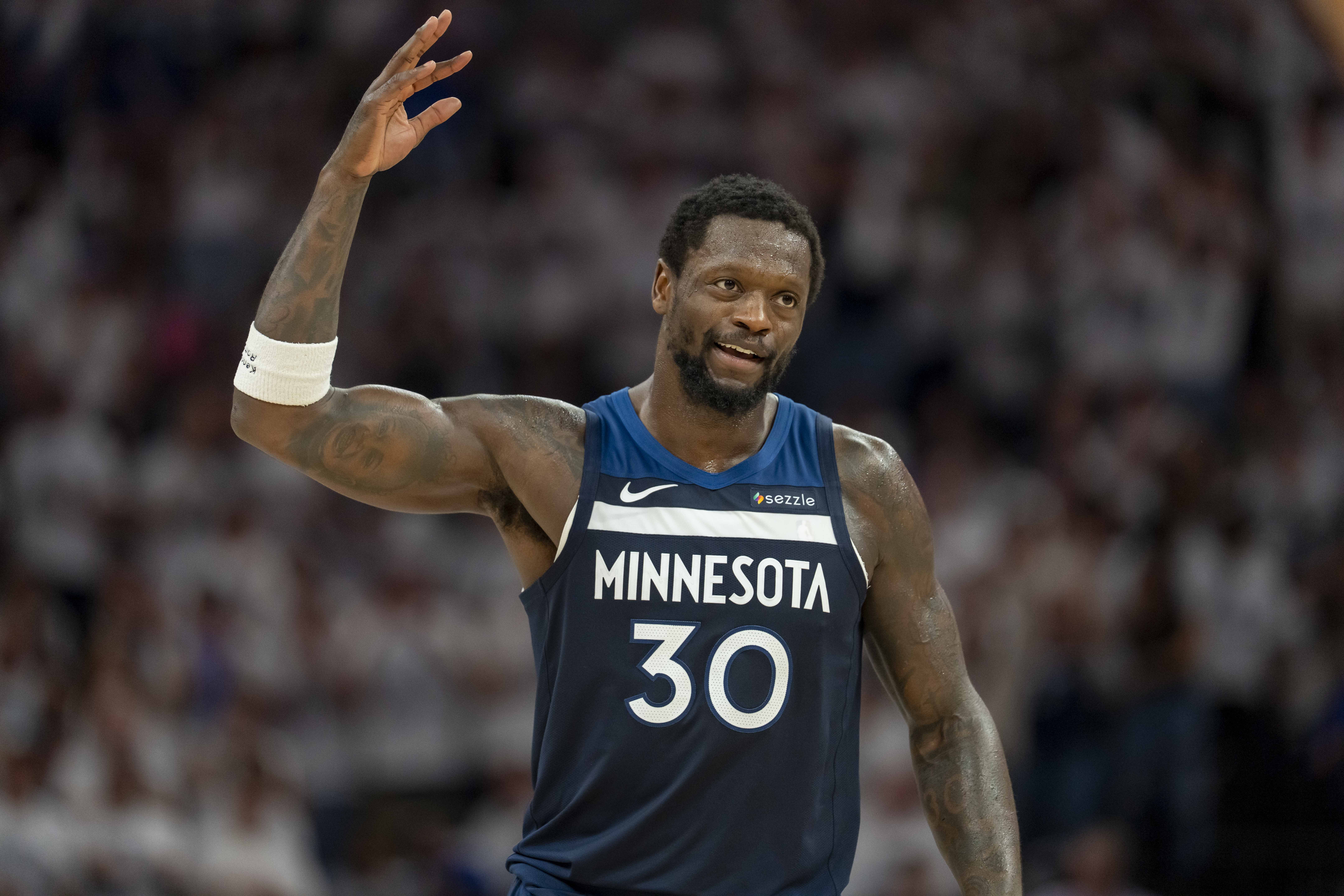 May 14, 2025; Minneapolis, Minnesota, USA; Minnesota Timberwolves forward Julius Randle (30) raises his arm to pump up the crowd after making a shot against the Golden State Warriors in the first half during game five of the second round for the 2025 NBA Playoffs at Target Center. Mandatory Credit: Jesse Johnson-Imagn Images  