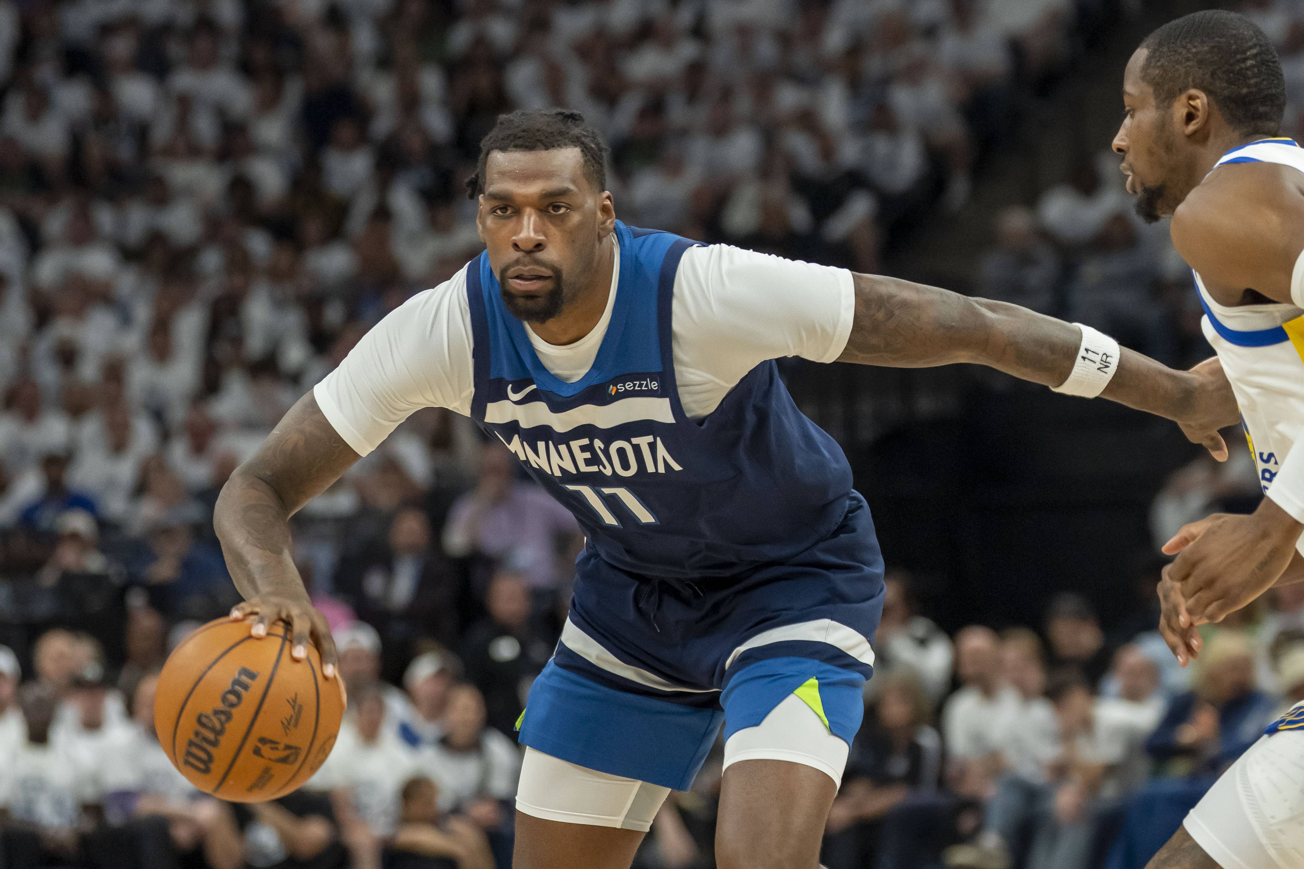 Minneapolis, Minnesota, USA; Minnesota Timberwolves center Naz Reid (11) dribbles the ball against the Golden State Warriors in the first half during game five of the second round for the 2025 NBA Playoffs at Target Center. Mandatory Credit: Jesse Johnson-Imagn Images