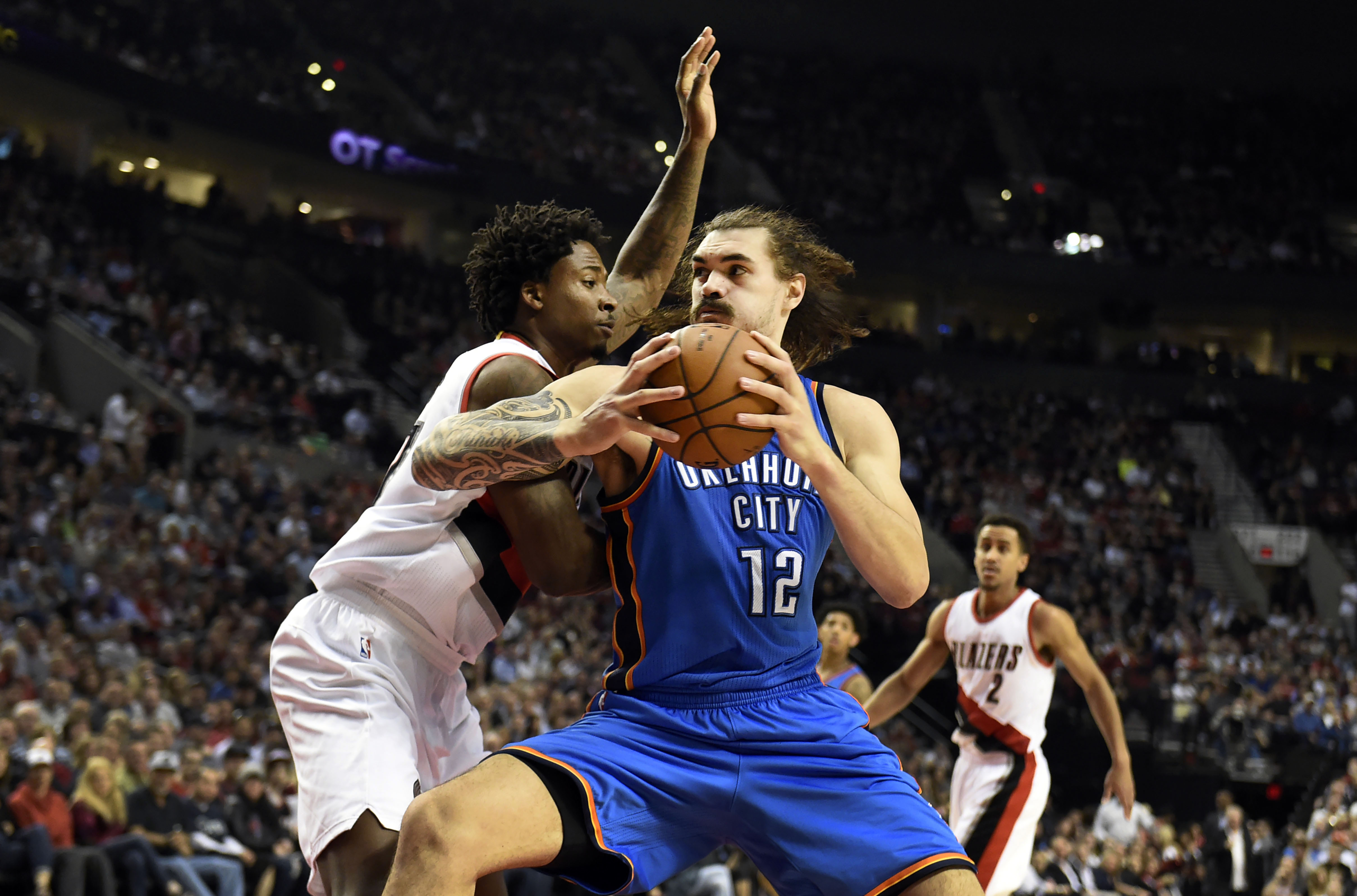Apr 6, 2016; Portland, OR, USA; Oklahoma City Thunder center Steven Adams (12) drives to the basket on Portland Trail Blazers center Ed Davis (17) during the first quarter of the game at the Moda Center at the Rose Quarter. Mandatory Credit: Steve Dykes-Imagn Images  