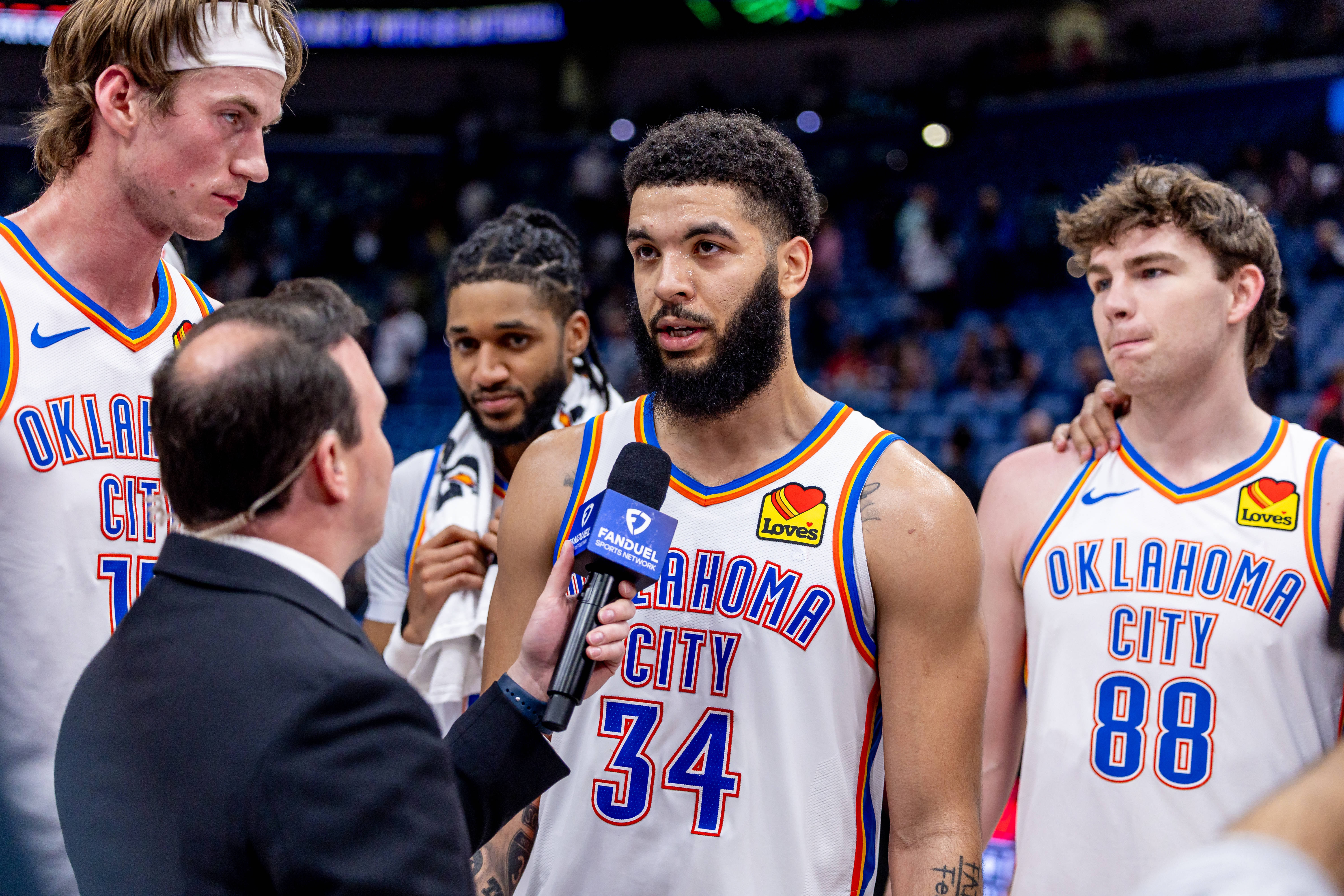 Apr 13, 2025; New Orleans, Louisiana, USA; Oklahoma City Thunder forward Kenrich Williams (34) and center Branden Carlson (15) and guard Alex Ducas (88) talk to reporter Nick Gallo after the game against the New Orleans Pelicans at Smoothie King Center. Mandatory Credit: Stephen Lew-Imagn Images