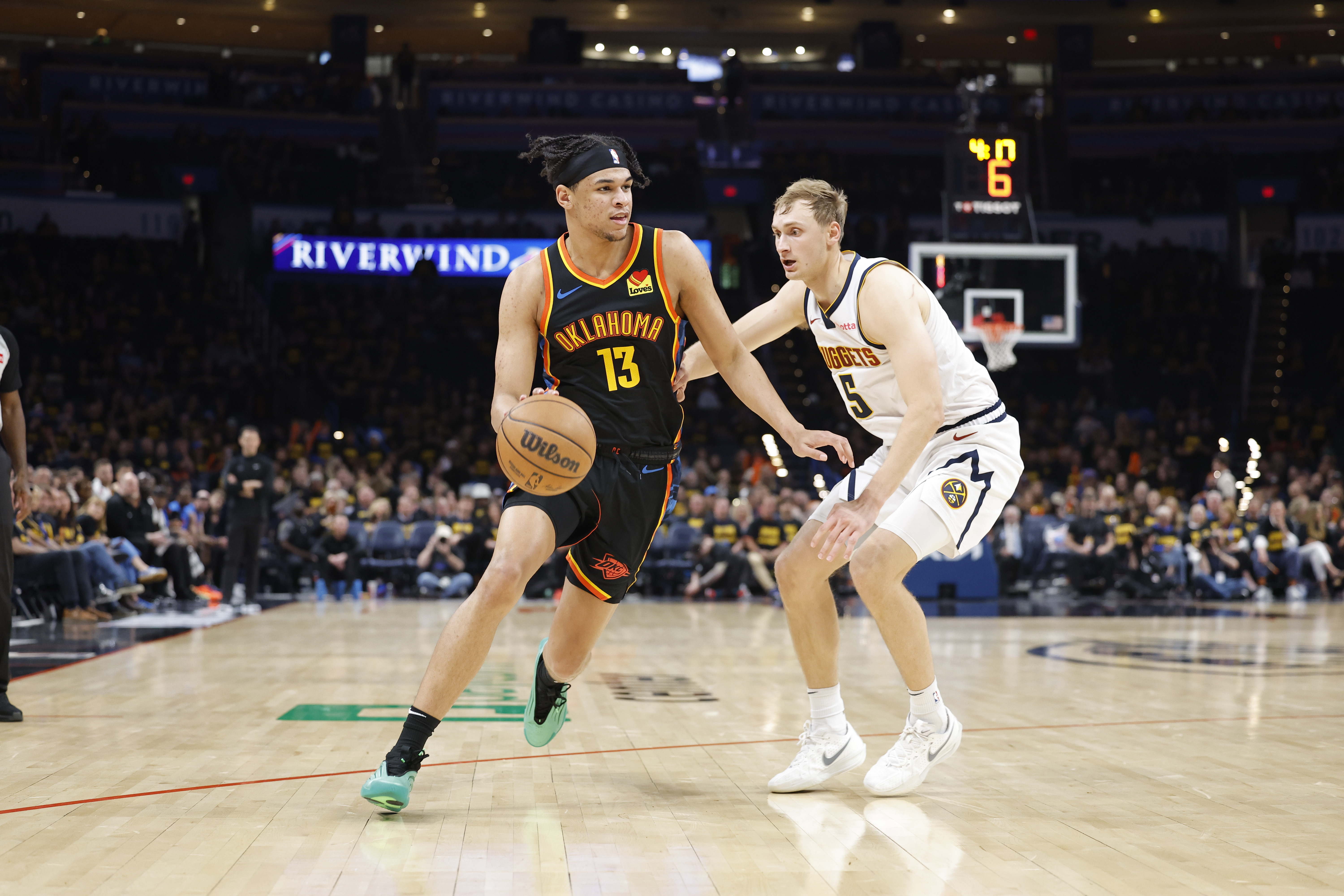 May 7, 2025; Oklahoma City, Oklahoma, USA; Oklahoma City Thunder forward Ousmane Dieng (13) drives to the basket around Denver Nuggets forward Hunter Tyson (5) in the second half during game two of the second round for the 2025 NBA Playoffs at Paycom Center. Mandatory Credit: Alonzo Adams-Imagn Images