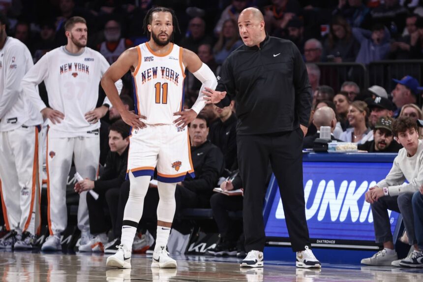 Jalen Brunson in conversation with Rick Brunson on the sidelines,