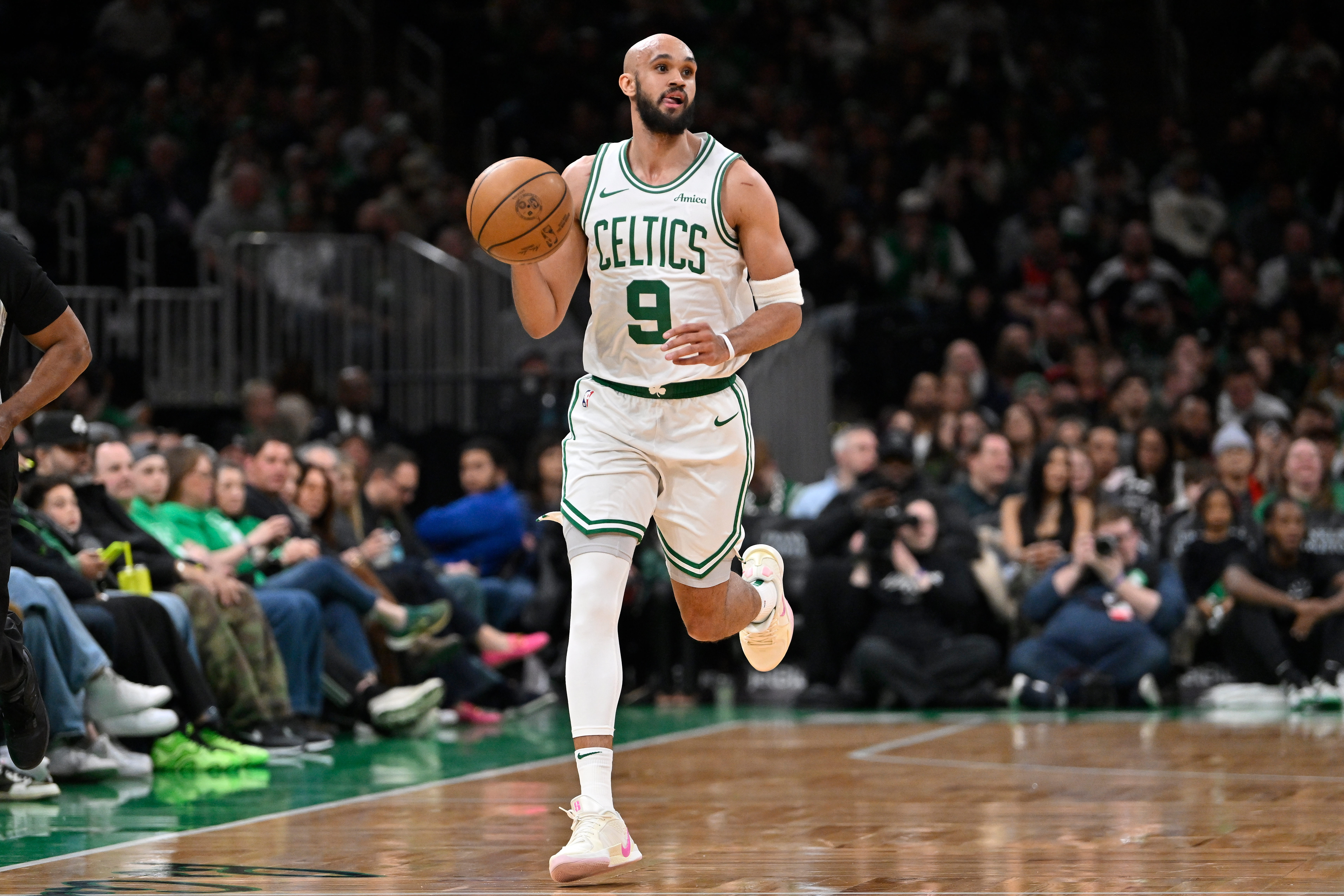 Apr 11, 2025; Boston, Massachusetts, USA; Boston Celtics guard Derrick White (9) dribbles the ball against the Charlotte Hornets during the first half at TD Garden. Mandatory Credit: Eric Canha-Imagn Images  