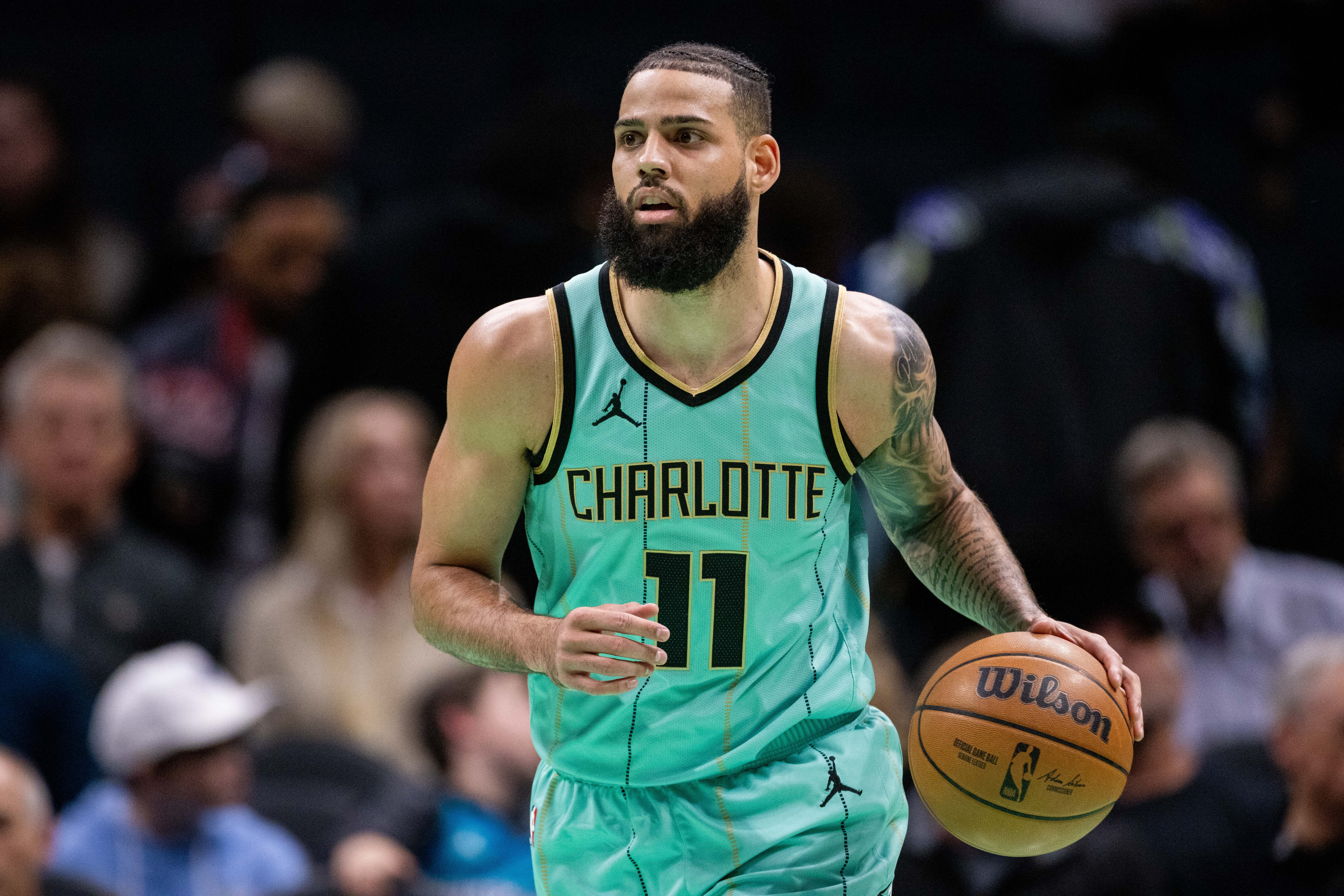 Jan 24, 2025; Charlotte, North Carolina, USA; Charlotte Hornets forward Cody Martin (11) brings the ball up court against the Portland Trail Blazers during the first quarter at Spectrum Center. Mandatory Credit: Scott Kinser-Imagn Images  