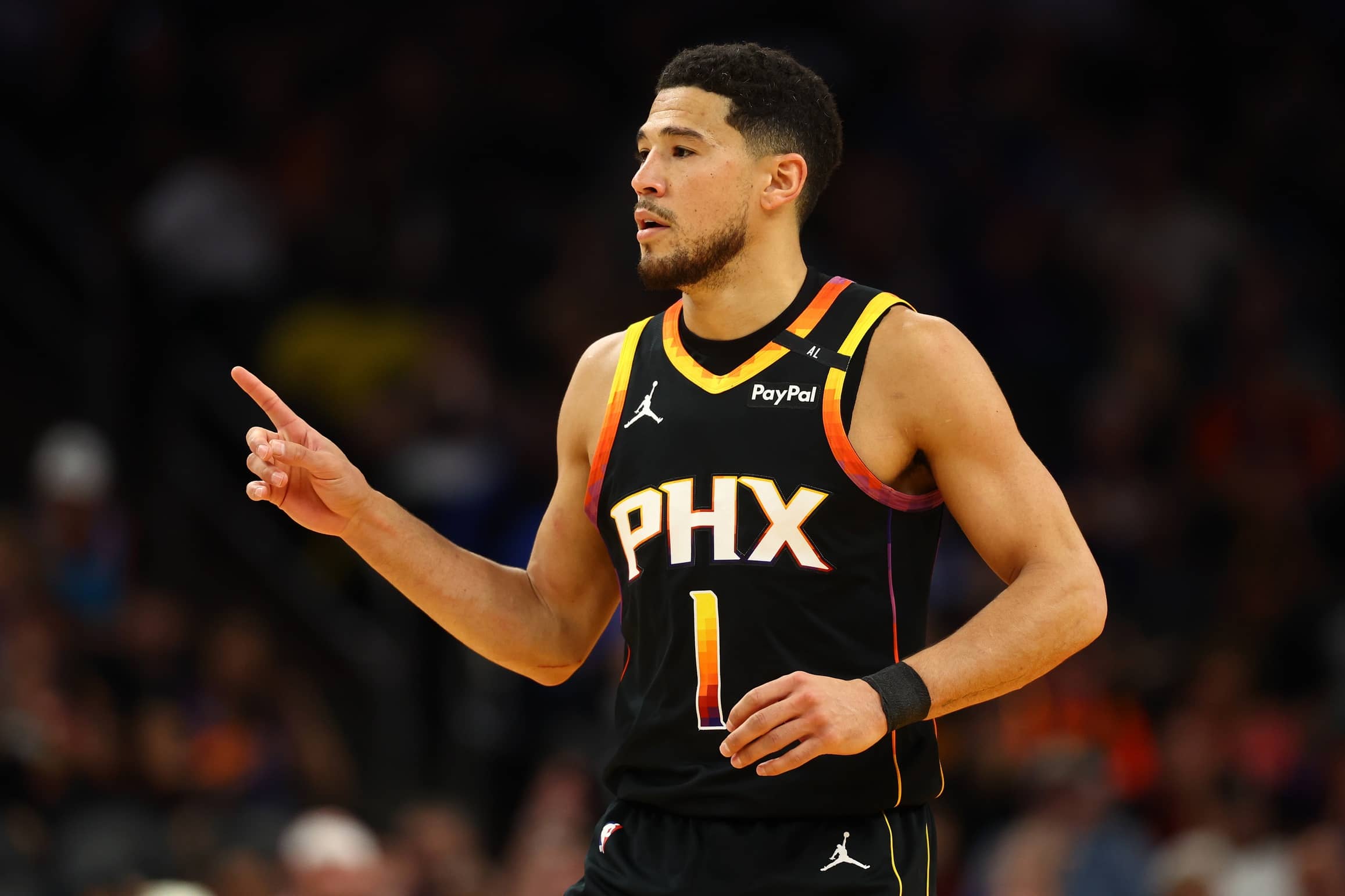 Devin Booker reacts after a play against the Oklahoma City Thunder during the first half at Footprint Center