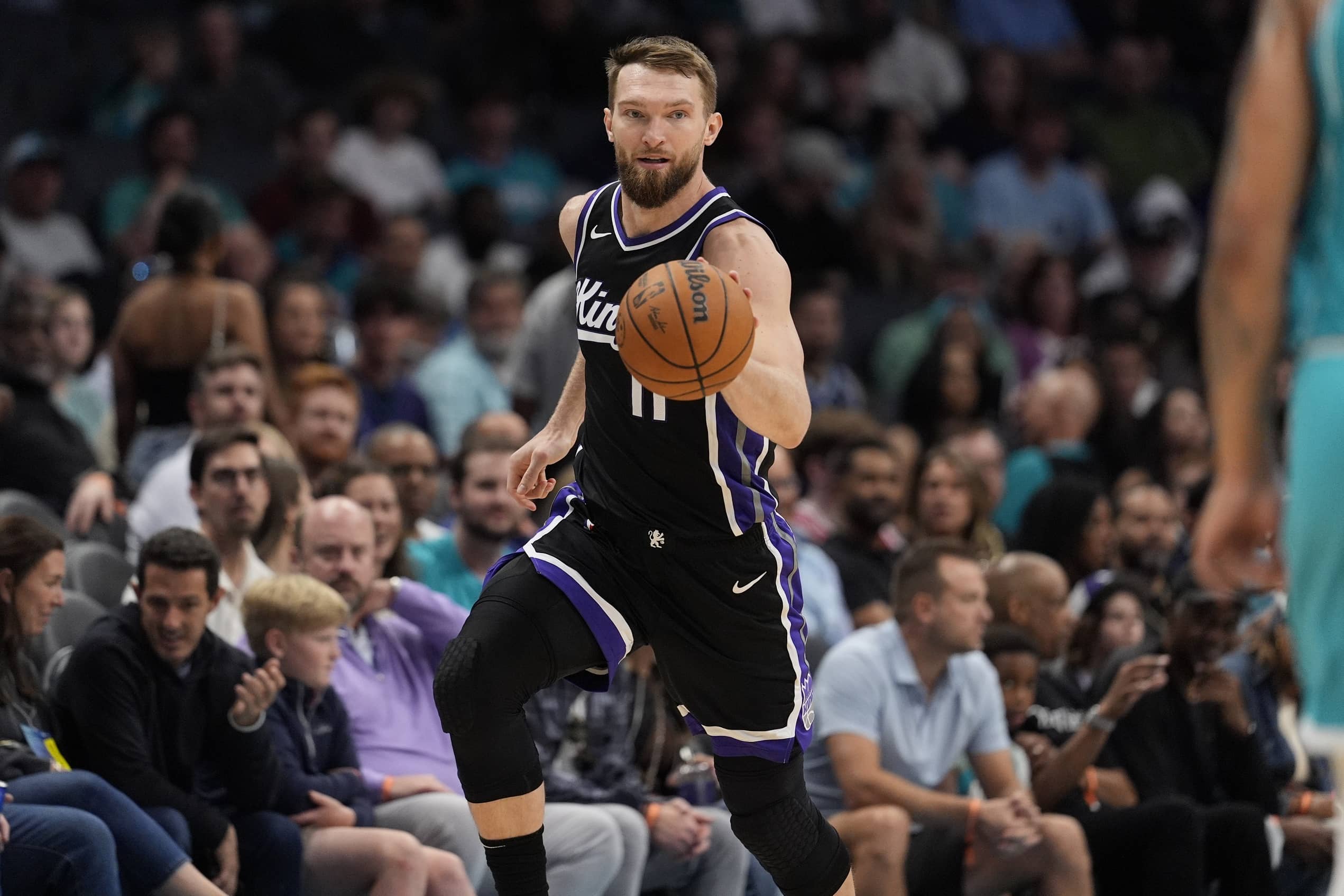 Apr 4, 2025; Charlotte, North Carolina, USA; Sacramento Kings forward Domantas Sabonis (11) handles the ball against the Charlotte Hornets during the second quarter at Spectrum Center. Mandatory Credit: Jim Dedmon-Imagn Images