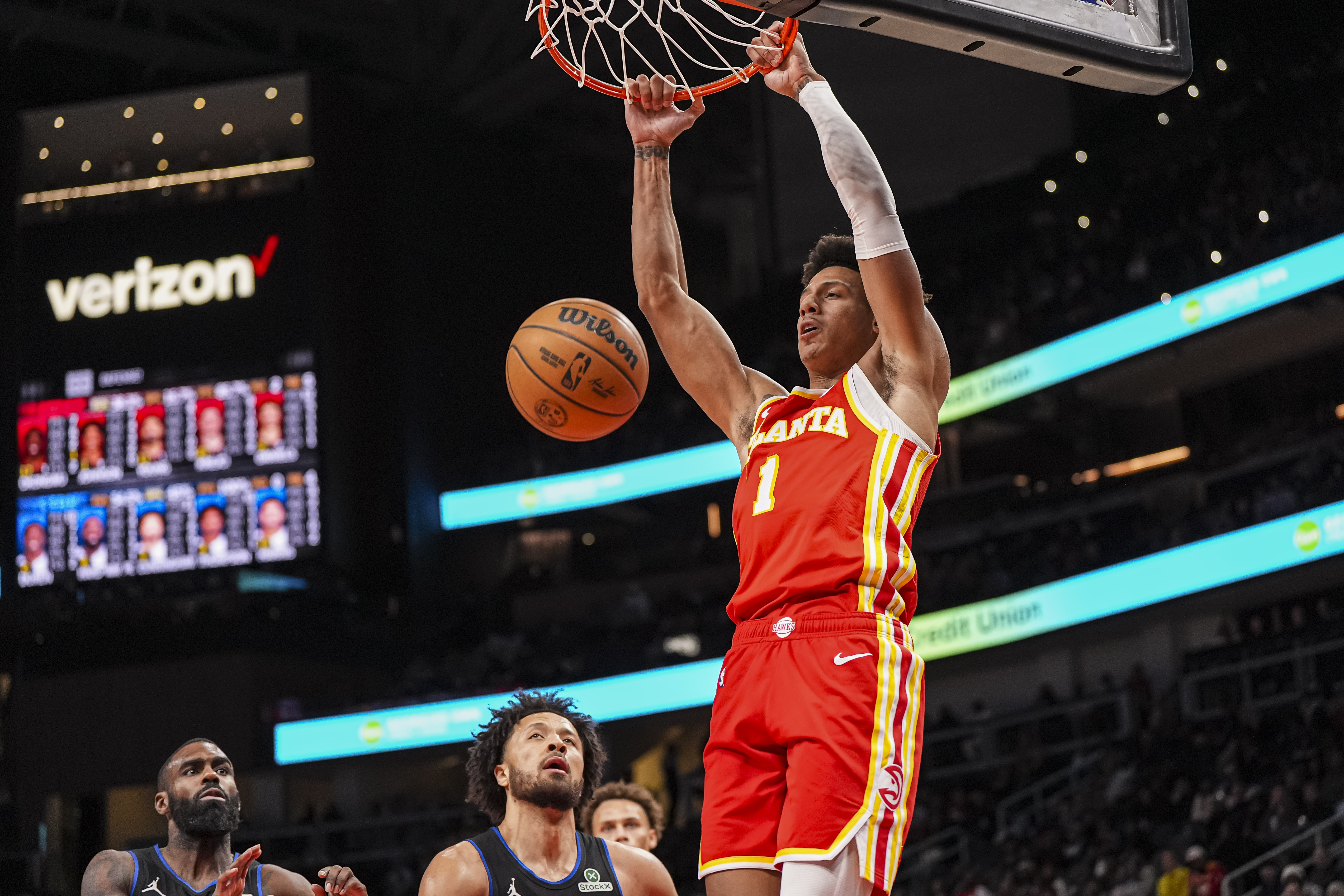 Jan 22, 2025; Atlanta, Georgia, USA; Atlanta Hawks forward Jalen Johnson (1) dunks the ball behind Detroit Pistons guard Cade Cunningham (2) during the second half at State Farm Arena. Mandatory Credit: Dale Zanine-Imagn Images  