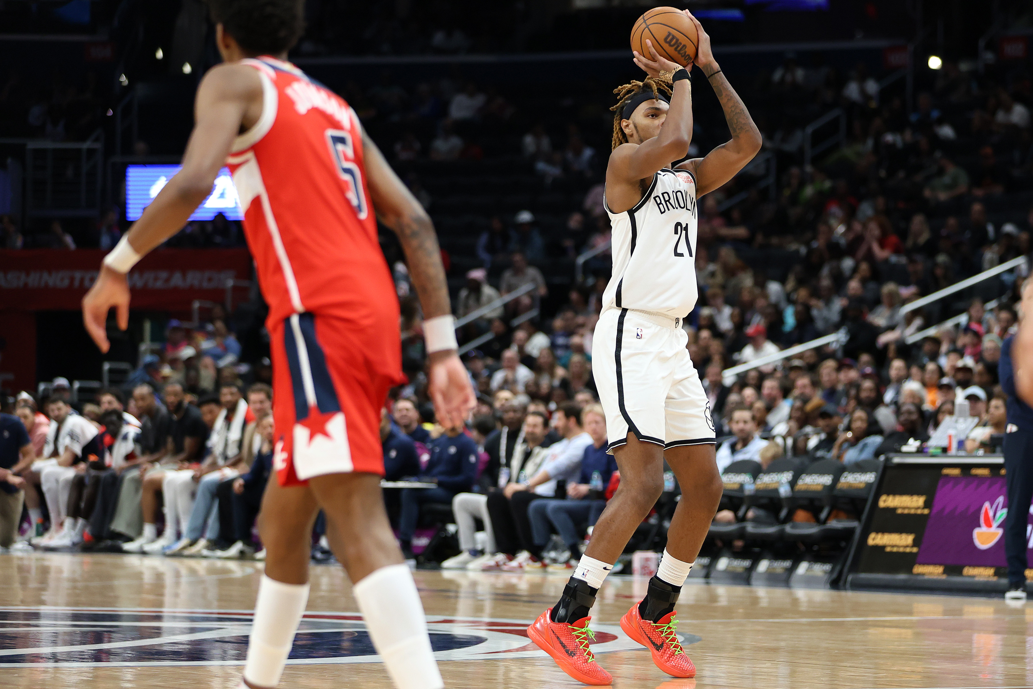 Mar 29, 2025; Washington, District of Columbia, USA; Brooklyn Nets forward Noah Clowney (21) takes a shot over Washington Wizards guard AJ Johnson (5) during the first half at Capital One Arena. Mandatory Credit: Daniel Kucin Jr.-Imagn Images  