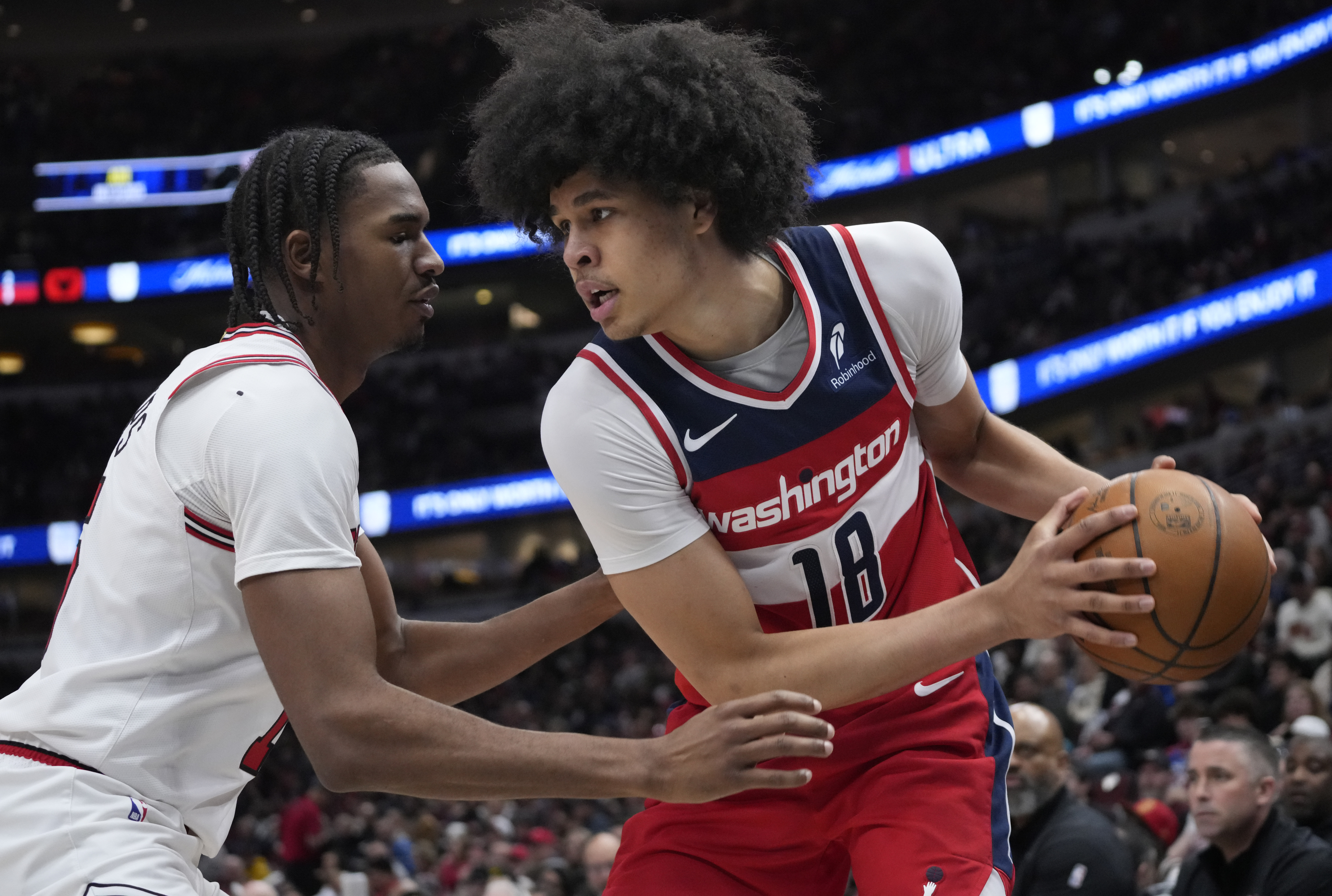 Apr 11, 2025; Chicago, Illinois, USA;Chicago Bulls forward Julian Phillips (15) defends Washington Wizards forward Kyshawn George (18) during the second half at United Center. Mandatory Credit: David Banks-Imagn Images  