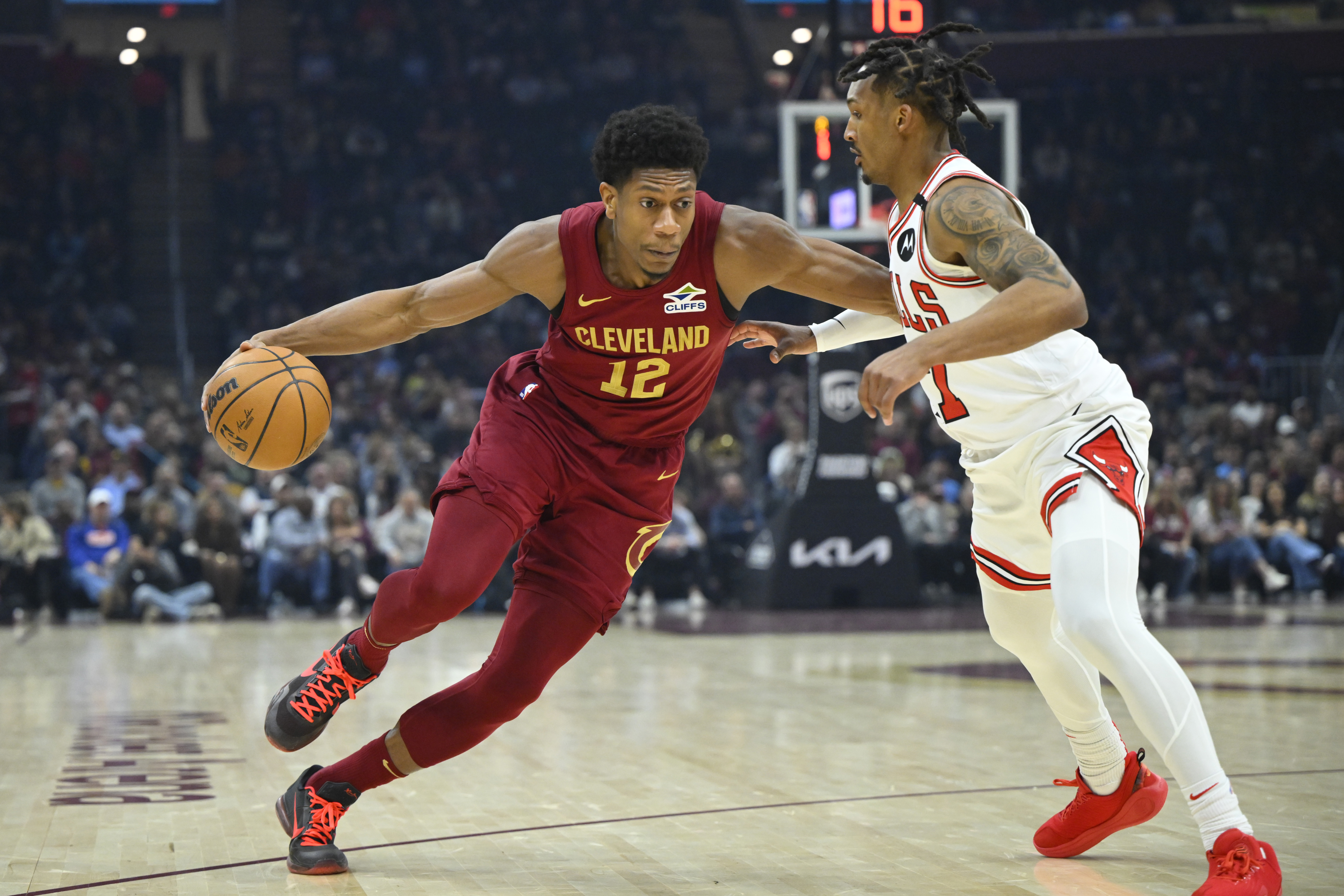 Apr 8, 2025; Cleveland, Ohio, USA; Cleveland Cavaliers forward De'Andre Hunter (12) dribbles bees Chicago Bulls guard Jahmir Young (17) in the first quarter at Rocket Arena. Mandatory Credit: David Richard-Imagn Images  