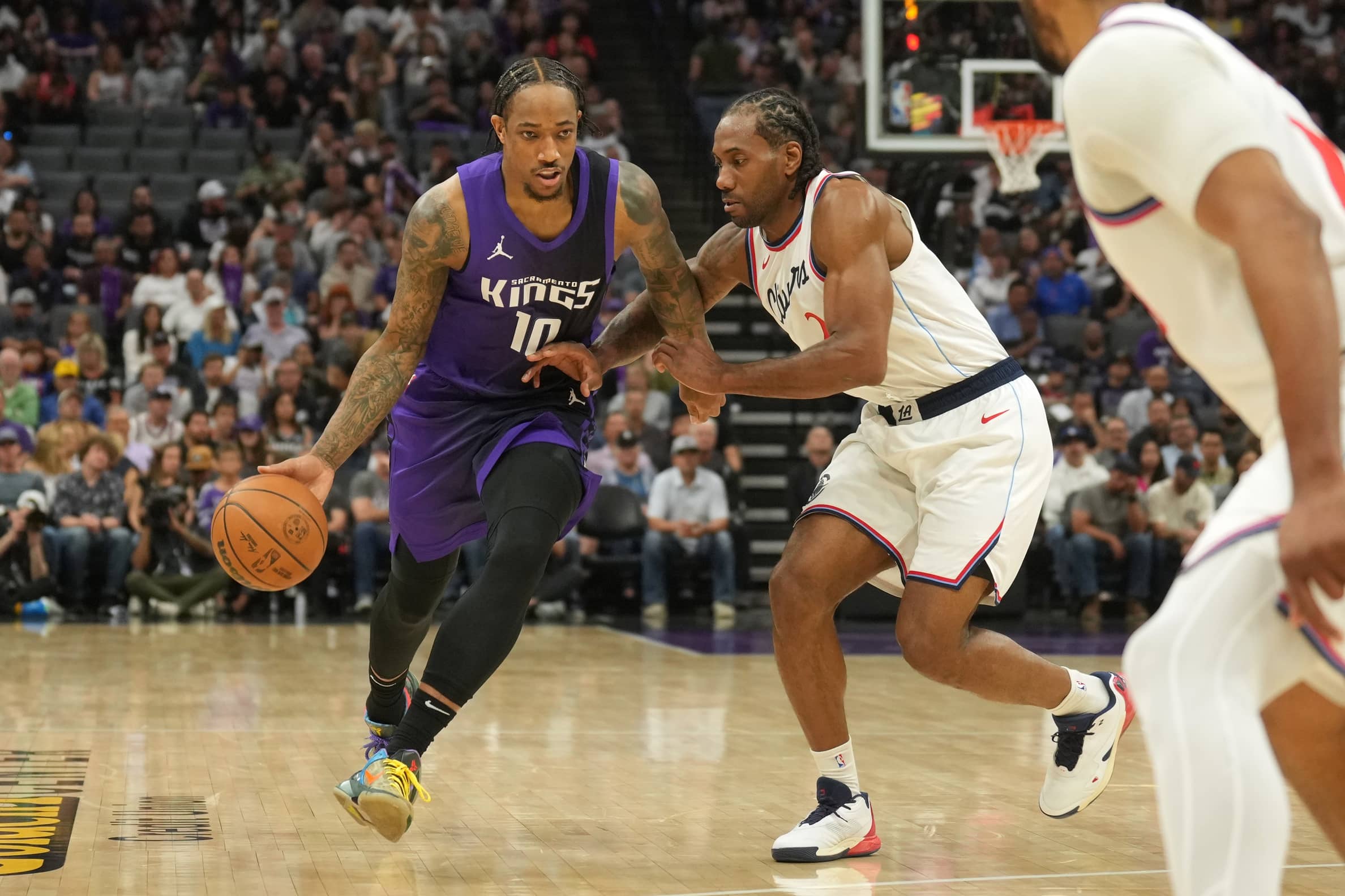 Apr 11, 2025; Sacramento, California, USA; Sacramento Kings forward DeMar DeRozan (10) dribbles against Los Angeles Clippers forward Kawhi Leonard (center right) during the second quarter at Golden 1 Center. Mandatory Credit: Darren Yamashita-Imagn Images