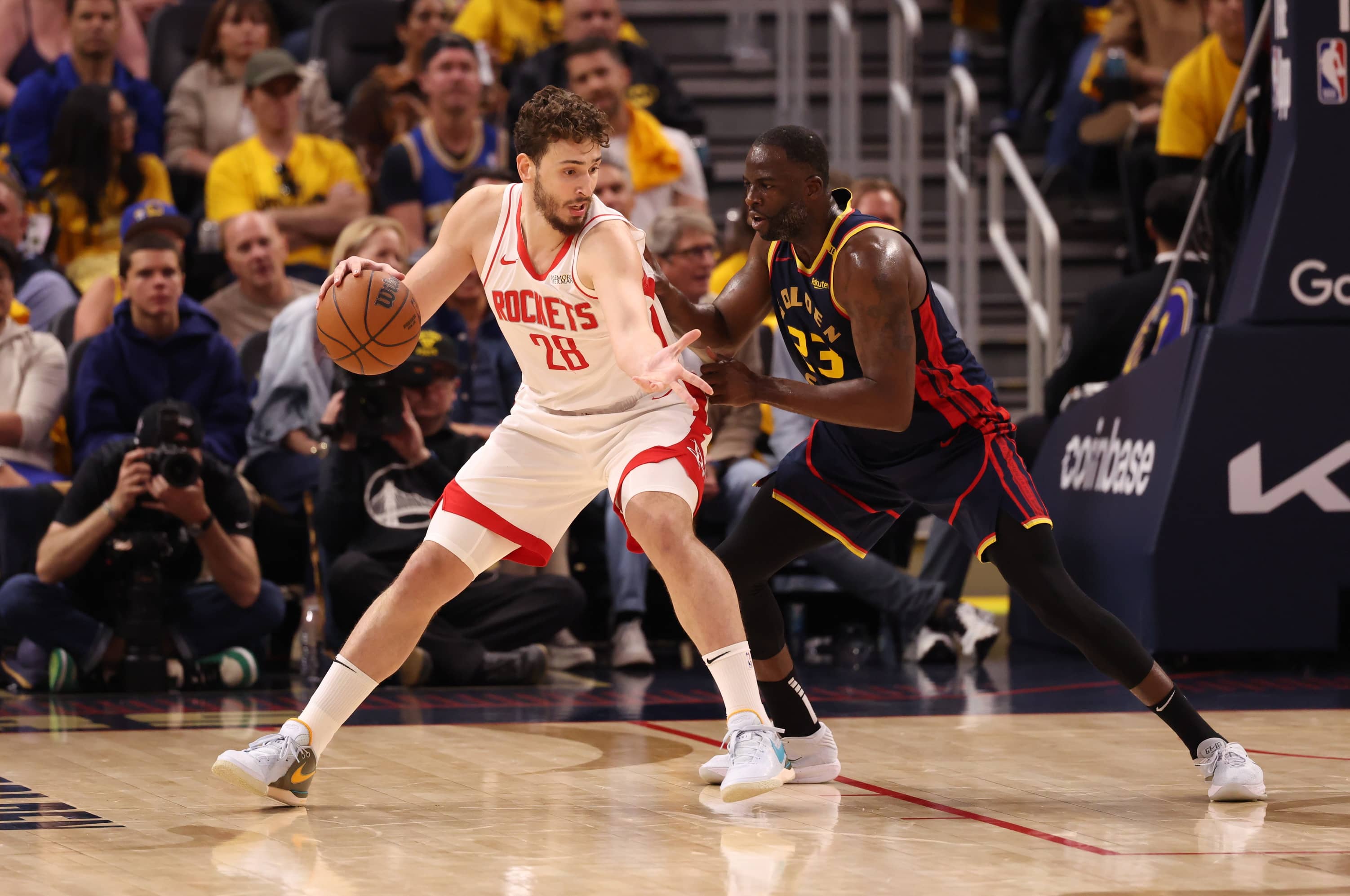San Francisco, California, USA; Houston Rockets center Alperen Sengun (28) controls the ball against Golden State Warriors forward Draymond Green (23) during the second quarter of Game 4 of the first round of the 2025 NBA Playoffs at Chase Center.