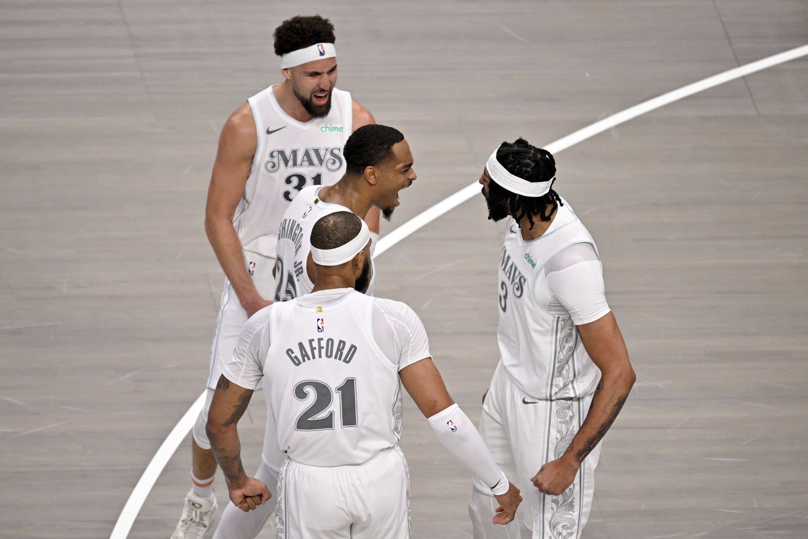 Dallas, Texas, USA; Dallas Mavericks forward Anthony Davis (3) and guard Klay Thompson (31) and forward P.J. Washington (25), and center Daniel Gafford (21) celebrate after Davis dunks the ball during the game between the Dallas Mavericks and the Houston Rockets at the American Airlines Center.