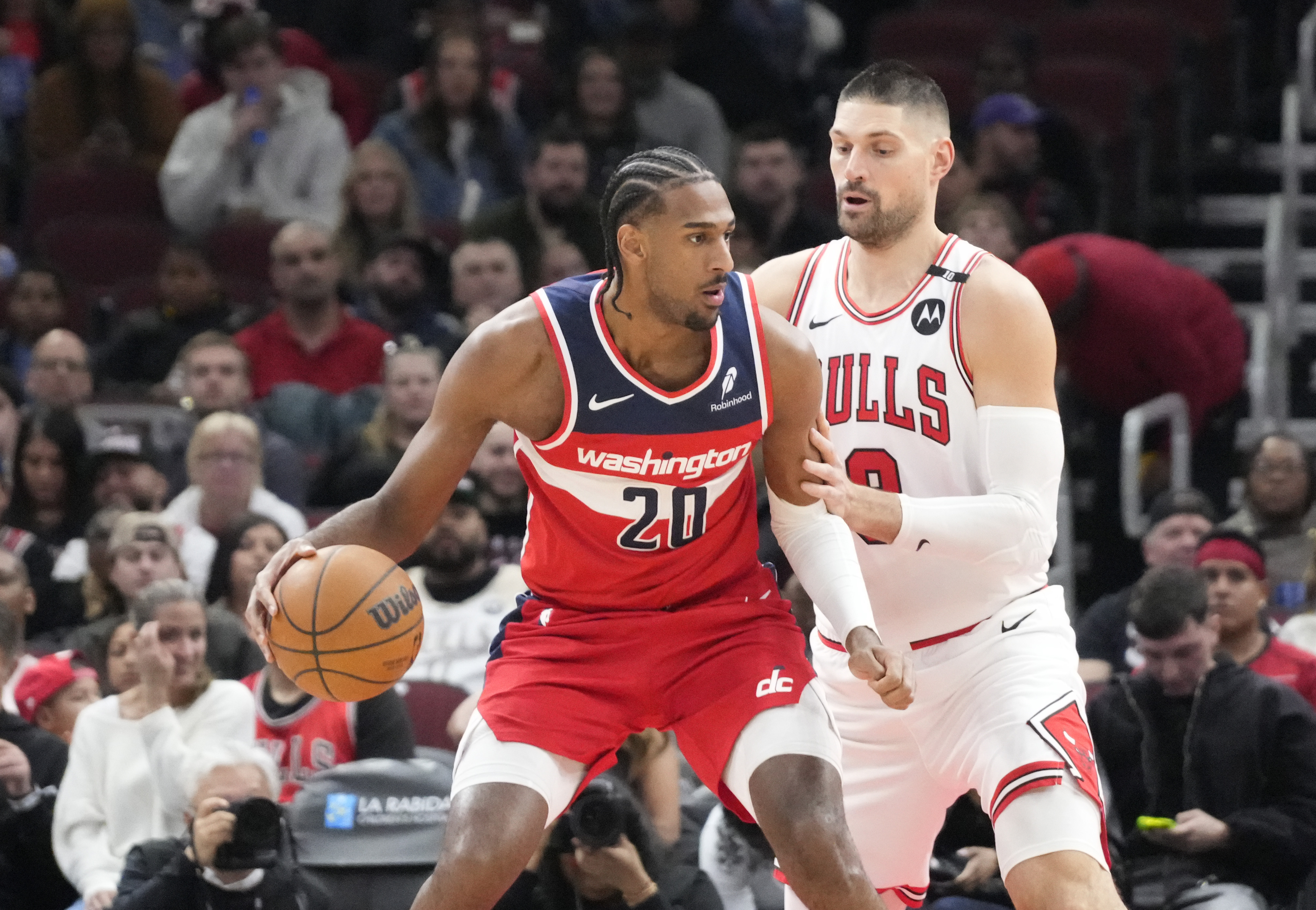 Apr 11, 2025; Chicago, Illinois, USA; Chicago Bulls center Nikola Vucevic (9) defends Washington Wizards forward Alex Sarr (20) during the first quarter at United Center. Mandatory Credit: David Banks-Imagn Images  