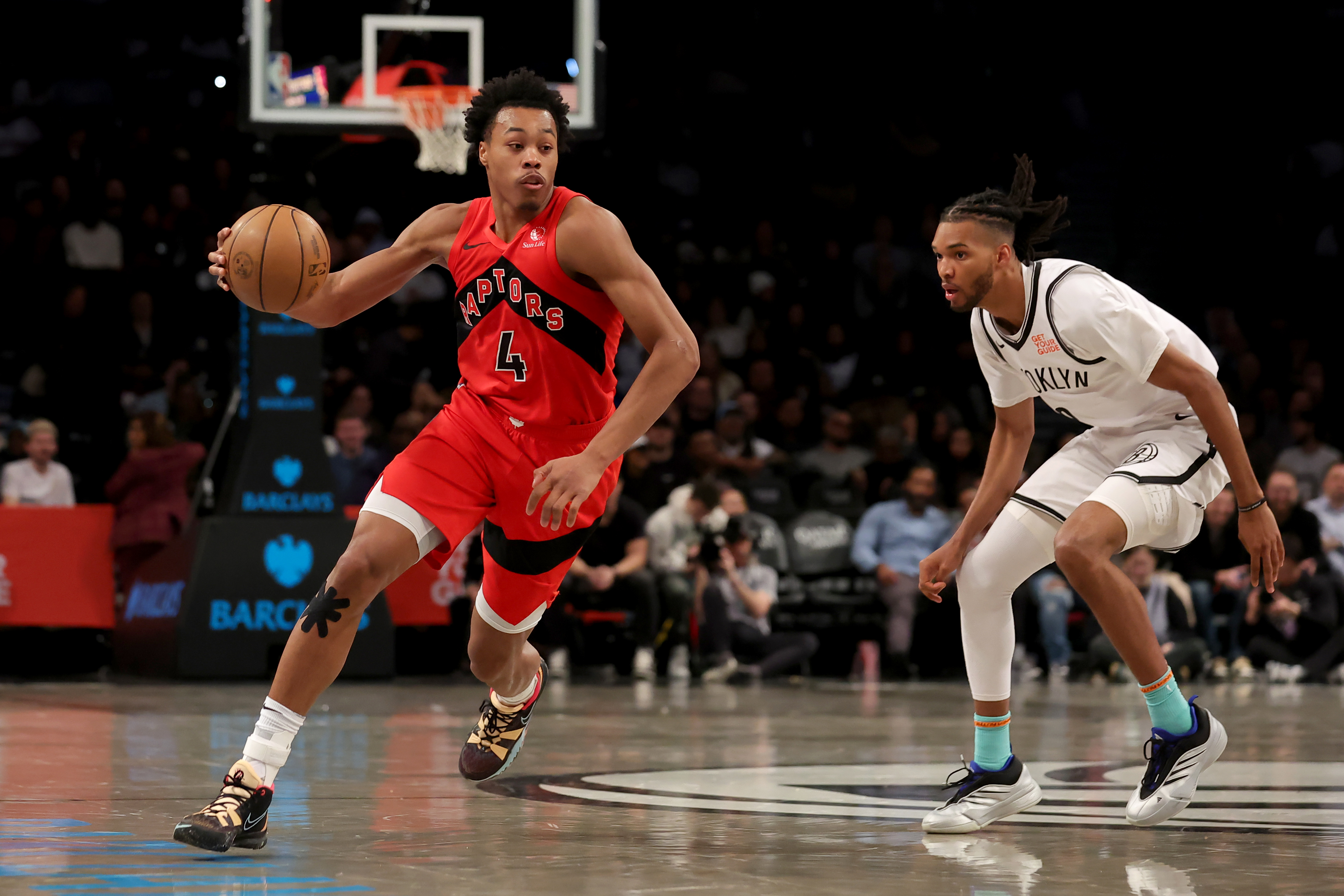Mar 26, 2025; Brooklyn, New York, USA; Toronto Raptors forward Scottie Barnes (4) drives to the basket against Brooklyn Nets forward Ziaire Williams (8) during the fourth quarter at Barclays Center. Mandatory Credit: Brad Penner-Imagn Images  