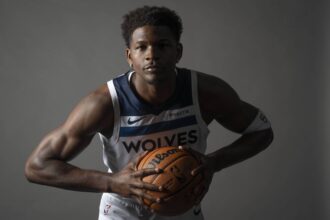 Minneapolis, MN, USA; Minnesota Timberwolves guard Anthony Edwards (5) poses for a photograph as part of media day at Target Center. Mandatory Credit: Bruce Kluckhohn-Imagn Images