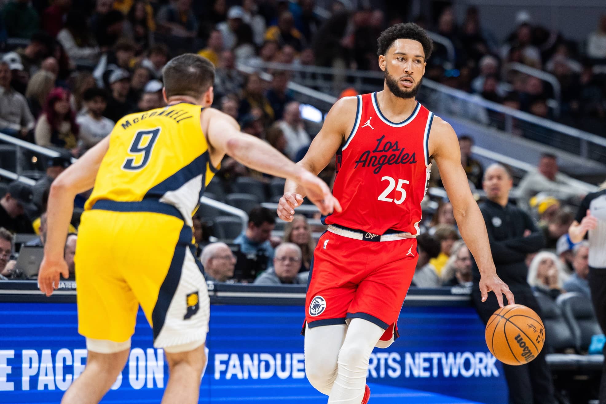 Indianapolis, Indiana, USA; LA Clippers guard Ben Simmons (25) dribbles the ball while Indiana Pacers guard T.J. McConnell (9) defends in the first half at Gainbridge Fieldhouse.