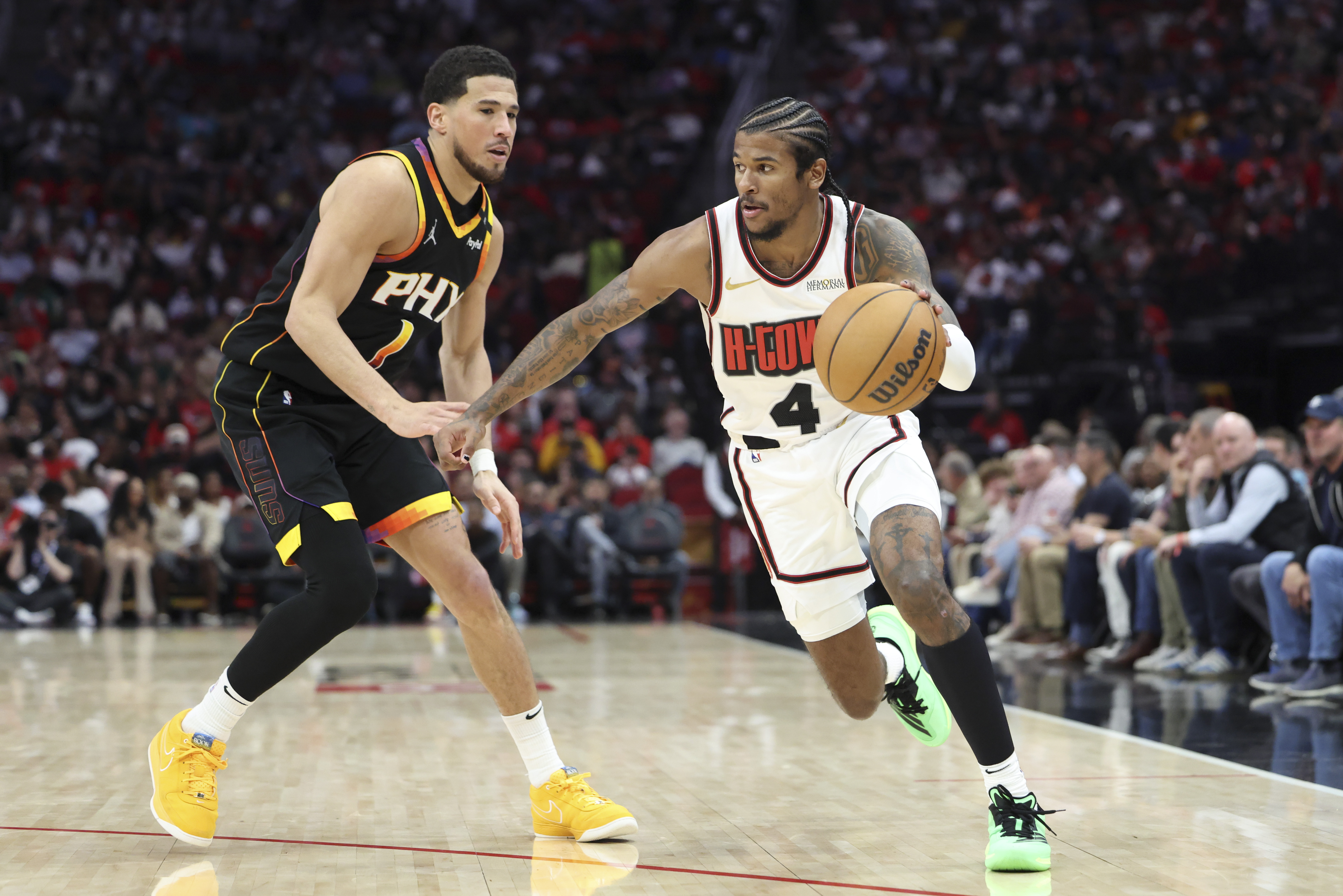 Mar 12, 2025; Houston, Texas, USA; Houston Rockets guard Jalen Green (4) dribbles the ball as Phoenix Suns guard Devin Booker (1) defends during the third quarter at Toyota Center. Mandatory Credit: Troy Taormina-Imagn Images  