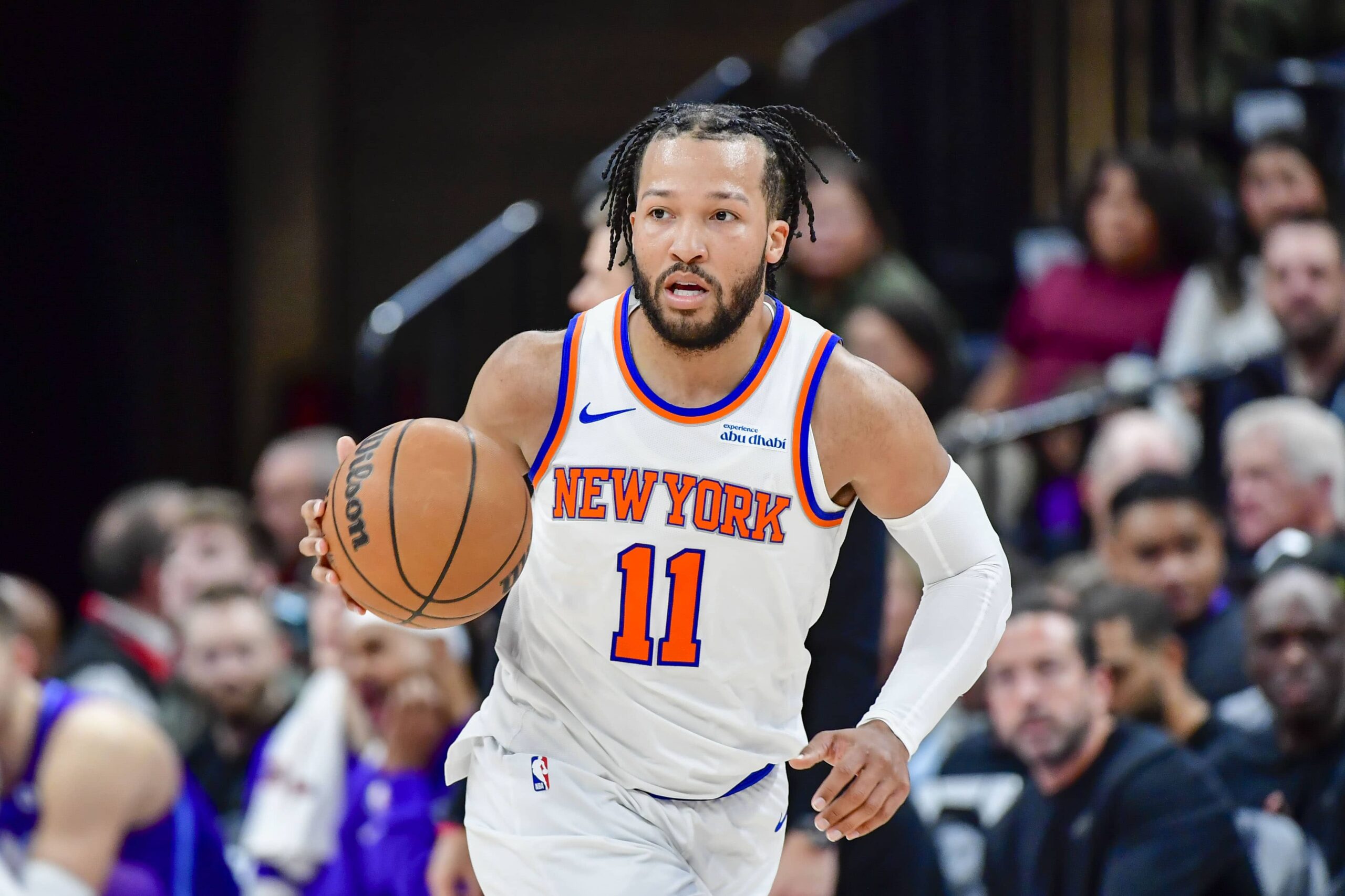 New York Knicks guard Jalen Brunson (11) dribbles the ball downcourt against the Utah Jazz during the first half at the Delta Center.