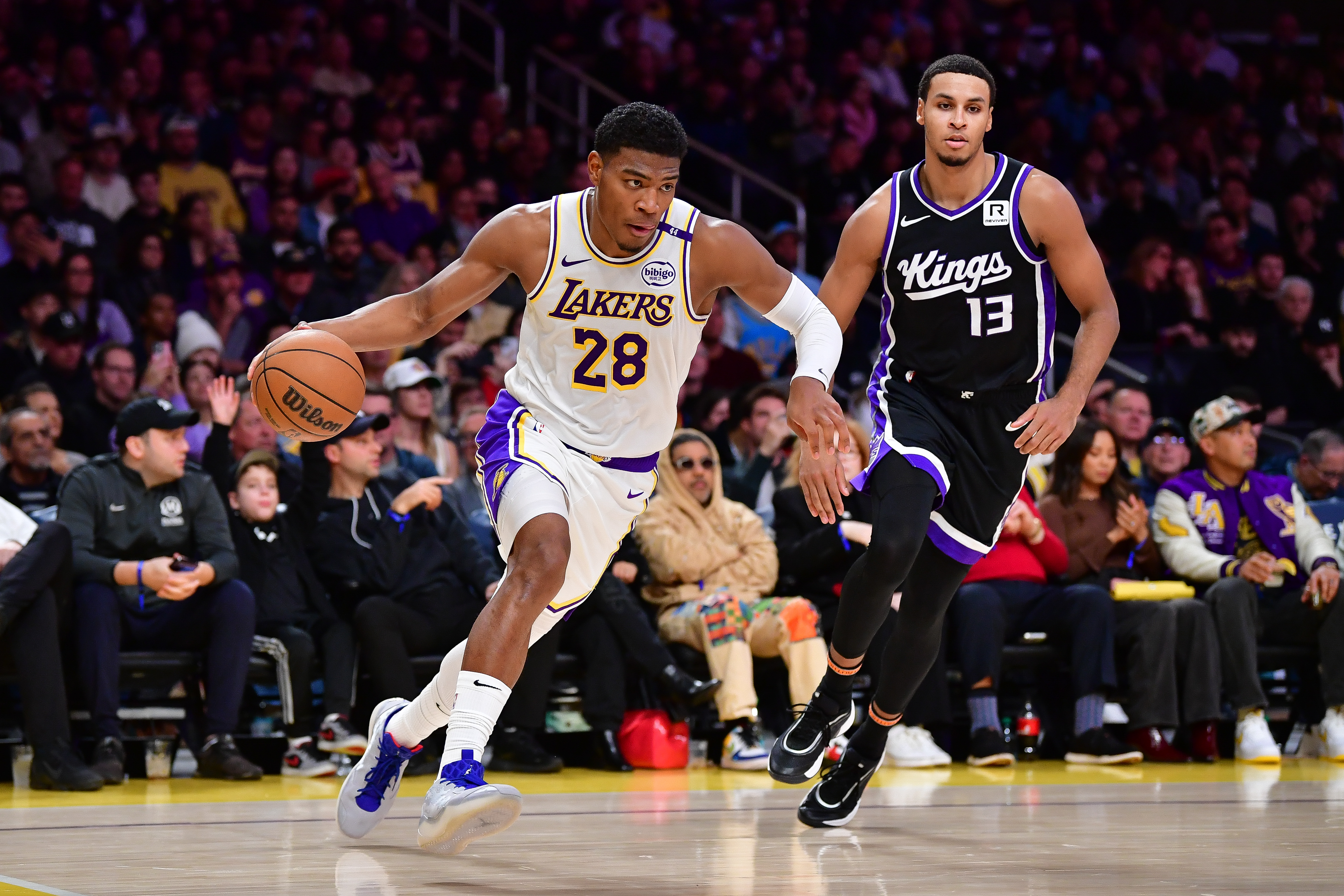 Dec 28, 2024; Los Angeles, California, USA; Los Angeles Lakers forward Rui Hachimura (28) moves the ball ahead of Sacramento Kings forward Keegan Murray (13) during the second half at Crypto.com Arena. Mandatory Credit: Gary A. Vasquez-Imagn Images  