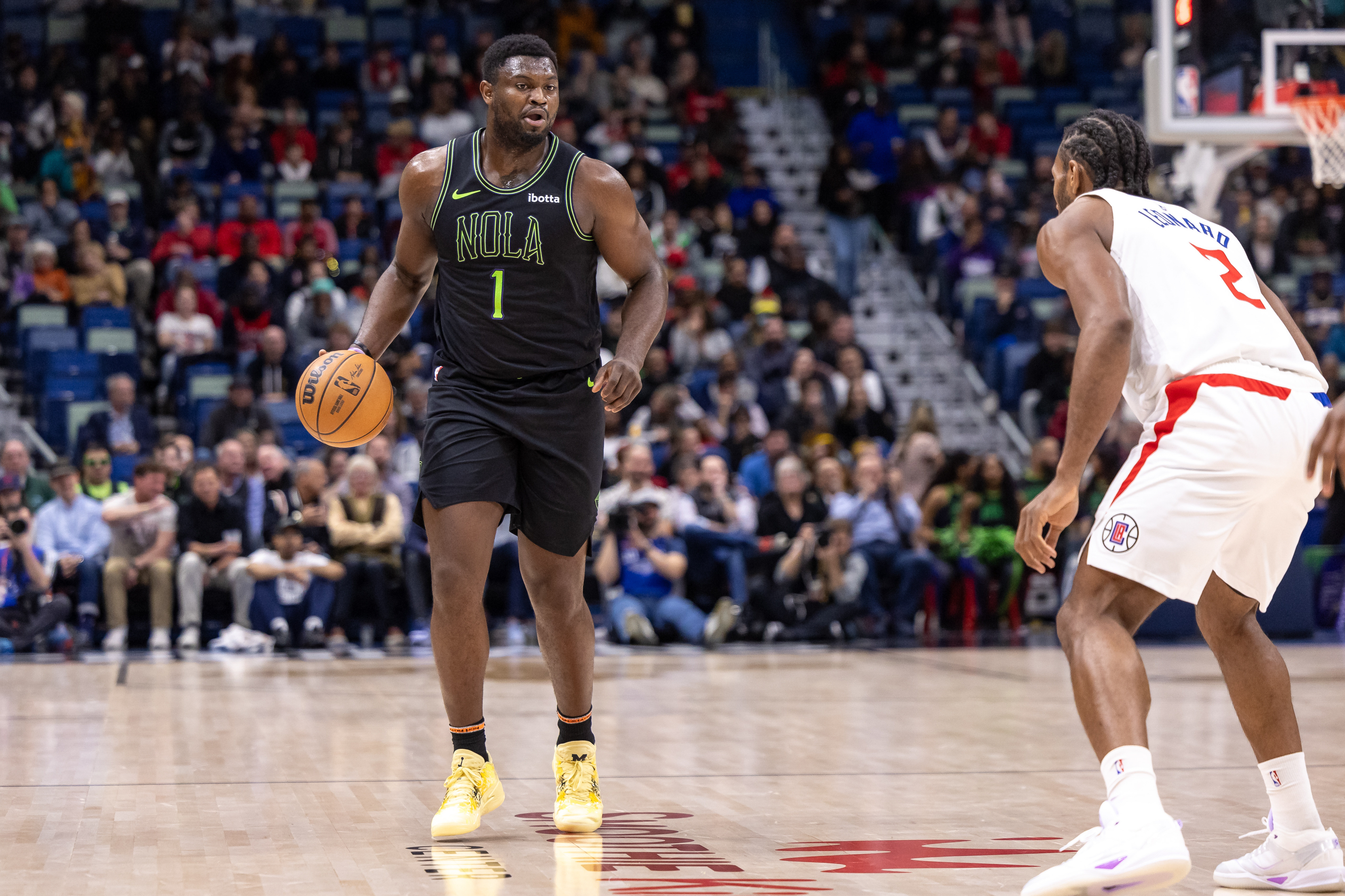 Jan 5, 2024; New Orleans, Louisiana, USA; New Orleans Pelicans forward Zion Williamson (1) brings the ball up court against LA Clippers forward Kawhi Leonard (2) during the first half at Smoothie King Center. Mandatory Credit: Stephen Lew-Imagn Images  