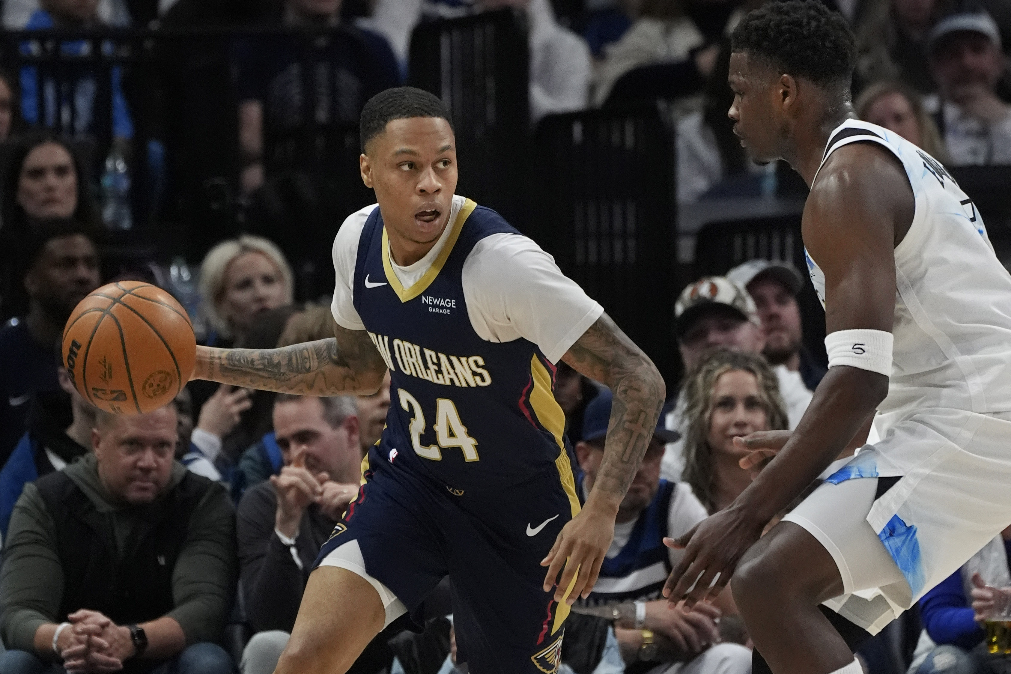 Mar 21, 2025; Minneapolis, Minnesota, USA; New Orleans Pelicans guard Jordan Hawkins (24) works around Minnesota Timberwolves guard Anthony Edwards (5) in the first quarter at Target Center. Mandatory Credit: Bruce Kluckhohn-Imagn Images  