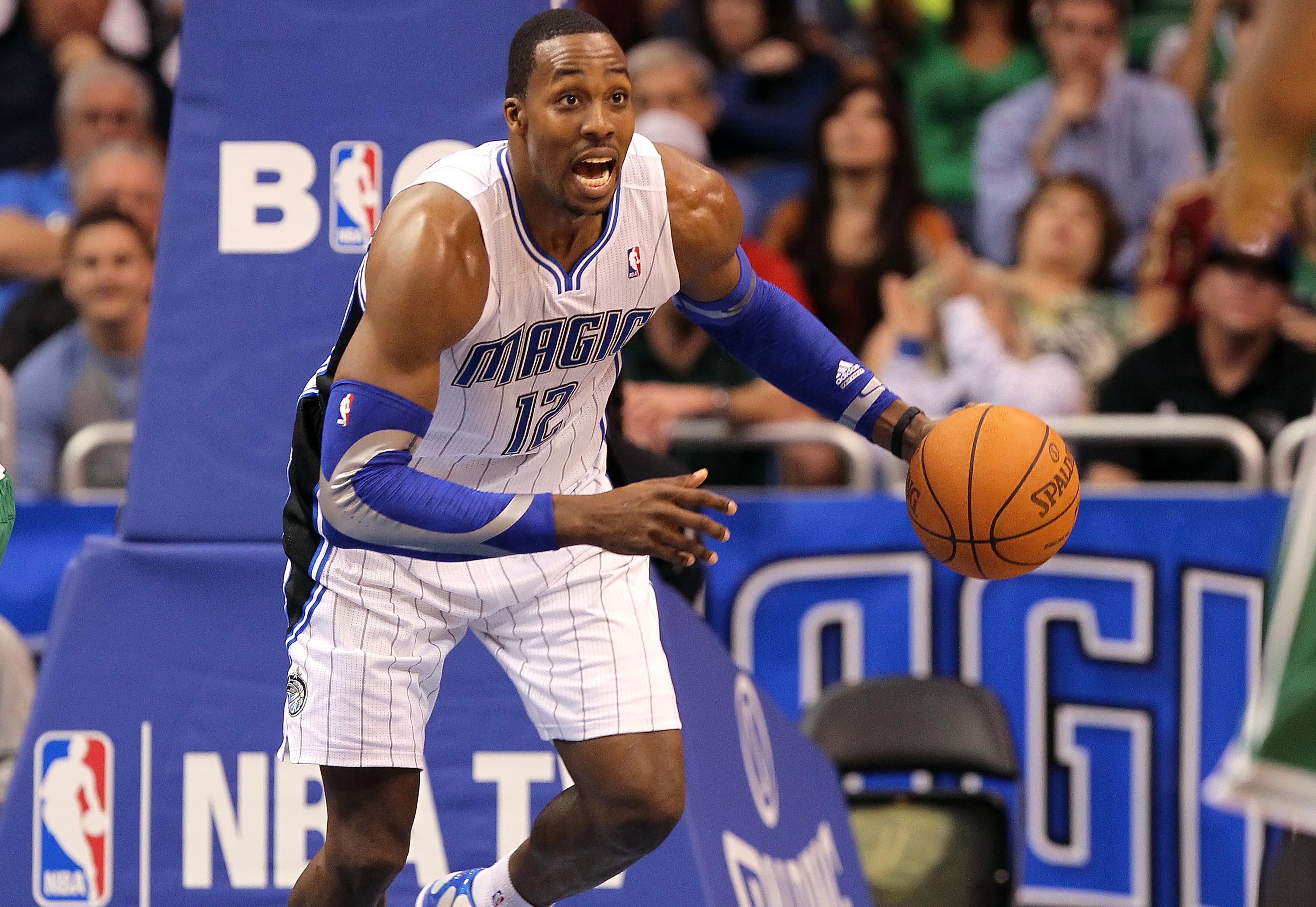 January 26, 2012; Orlando FL, USA; Orlando Magic center Dwight Howard (12) drives to the basket during the second half against the Boston Celtics at Amway Center. Boston Celtics defeated the Orlando Magic 91-83. Mandatory Credit: Kim Klement-Imagn Images  