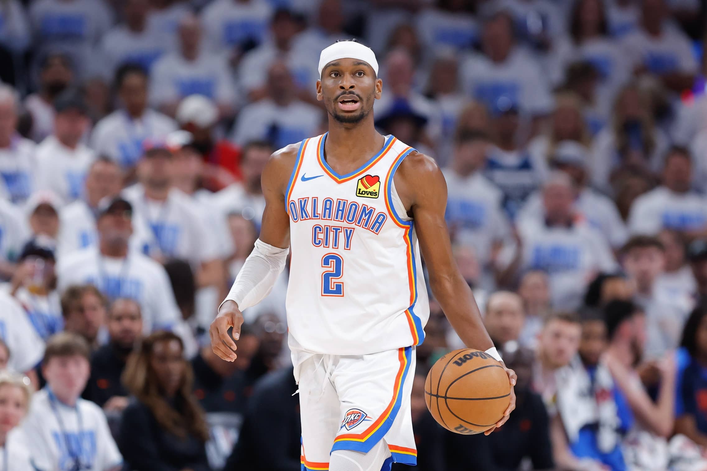 Shai Gilgeous-Alexander dribbles during a game between the Oklahoma City Thunder and Minnesota Timberwolves.