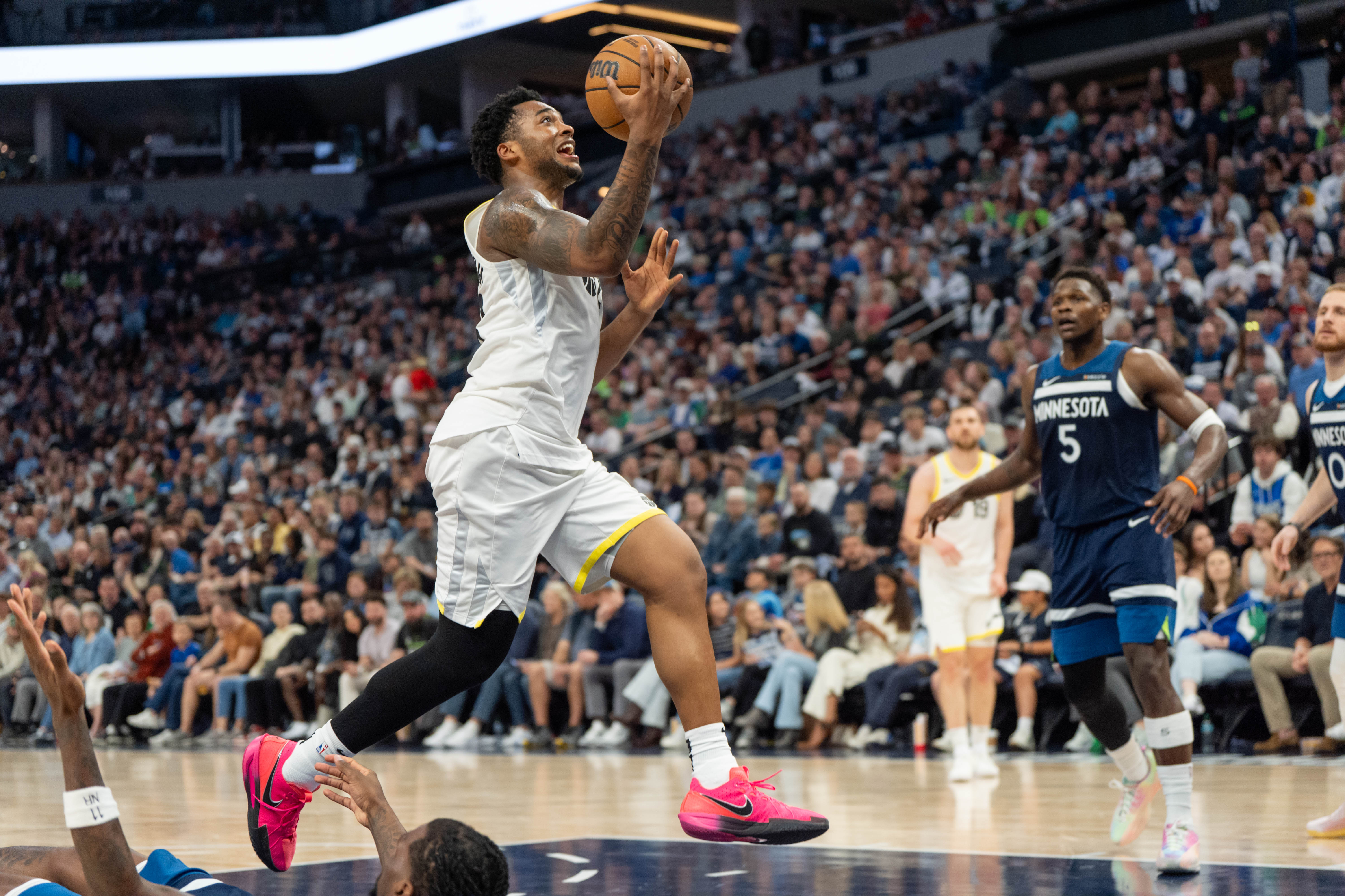 Apr 13, 2025; Minneapolis, Minnesota, USA; Utah Jazz forward Brice Sensabaugh (28) picks up a charging foul on Minnesota Timberwolves center Naz Reid (11) in the third quarter at Target Center. Mandatory Credit: Matt Blewett-Imagn Images  