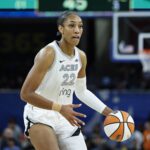 Aces center A'ja Wilson brings the ball up court during the second half of a WNBA game against the Sky at Wintrust Arena