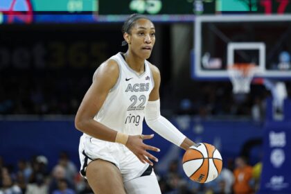 Aces center A'ja Wilson brings the ball up court during the second half of a WNBA game against the Sky at Wintrust Arena
