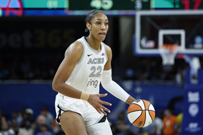 Aces center A'ja Wilson brings the ball up court during the second half of a WNBA game against the Sky at Wintrust Arena