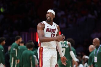Miami, Florida, USA; Miami Heat center Bam Adebayo (13) reacts against the Milwaukee Bucks during the second quarter at Kaseya Center. Mandatory Credit: Sam Navarro-Imagn Images