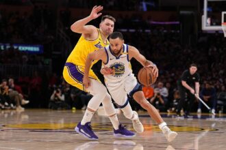 Oct 21, 2025; Los Angeles, California, USA; Golden State Warriors guard Stephen Curry (30) drives against Los Angeles Lakers guard Luka Doncic (77) during the second half at Crypto.com Arena. Mandatory Credit: William Liang-Imagn Images