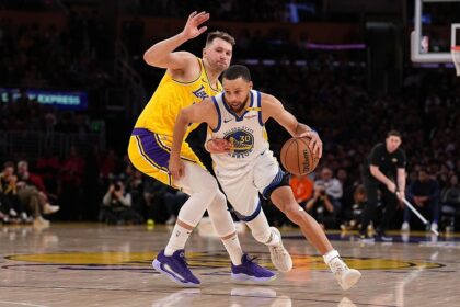 Oct 21, 2025; Los Angeles, California, USA; Golden State Warriors guard Stephen Curry (30) drives against Los Angeles Lakers guard Luka Doncic (77) during the second half at Crypto.com Arena. Mandatory Credit: William Liang-Imagn Images