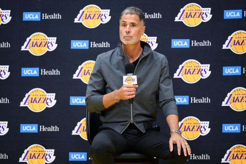 Lakers general manager Rob Pelinka, left, speaks during a press conference to preview the 2025-26 NBA season at UCLA Health Training Center.