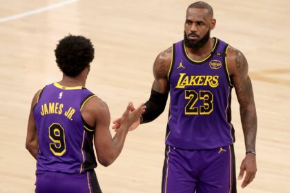 New York, New York, USA; Los Angeles Lakers guard Bronny James (9) checks in for forward LeBron James (23) during the fourth quarter against the New York Knicks at Madison Square Garden. Mandatory Credit: Brad Penner-Imagn Images