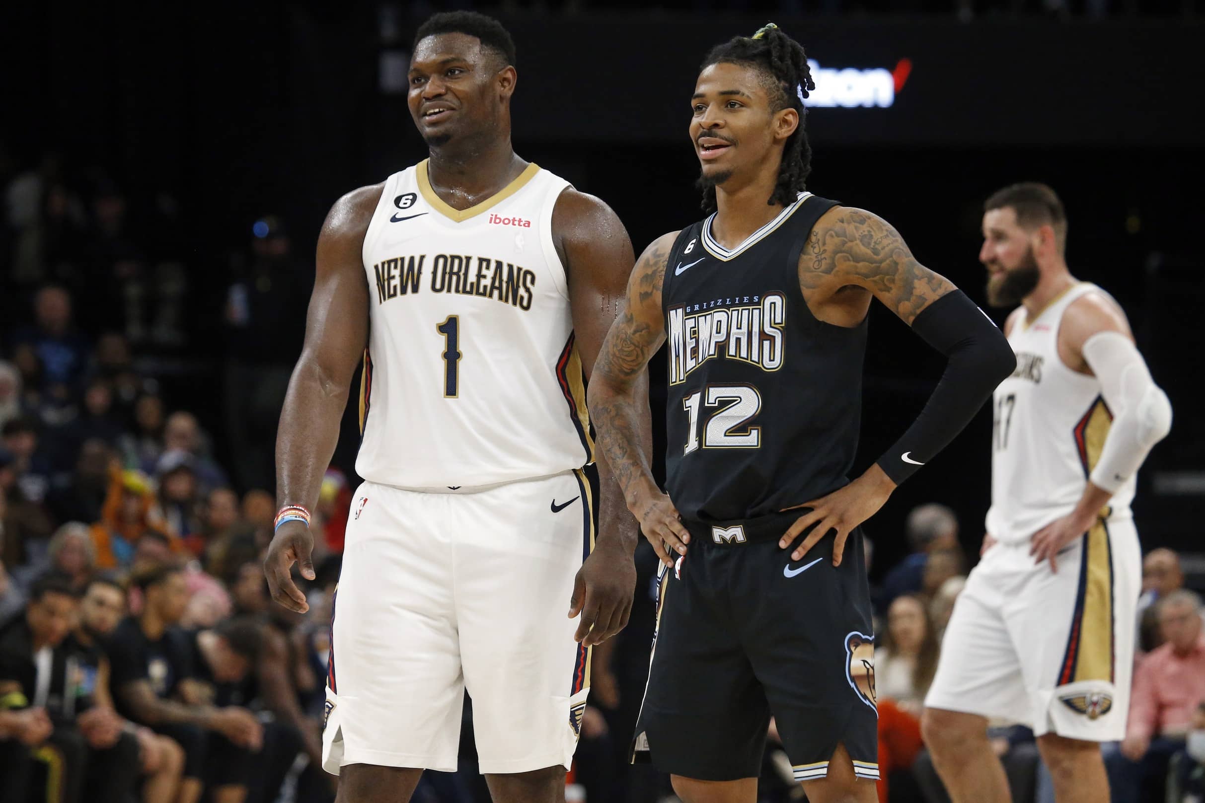 Nov 25, 2022; Memphis, Tennessee, USA; New Orleans Pelicans forward Zion Williamson (1) and Memphis Grizzlies guard Ja Morant (12) talk during free throws during the second half at FedExForum. Mandatory Credit: Petre Thomas-Imagn Images