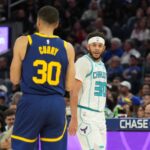 Feb 23, 2024; San Francisco, California, USA; Charlotte Hornets guard Seth Curry (right) talks with Golden State Warriors guard Stephen Curry (left) during the fourth quarter at Chase Center. Mandatory Credit: Darren Yamashita-Imagn Images