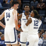 Oct 30, 2024; Memphis, Tennessee, USA; Memphis Grizzlies guard Ja Morant (12) talks with center Zach Edey (14) and forward Jaren Jackson Jr. (13) during the first half against the Brooklyn Nets at FedExForum. Mandatory Credit: Petre Thomas-Imagn Images