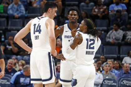 Oct 30, 2024; Memphis, Tennessee, USA; Memphis Grizzlies guard Ja Morant (12) talks with center Zach Edey (14) and forward Jaren Jackson Jr. (13) during the first half against the Brooklyn Nets at FedExForum. Mandatory Credit: Petre Thomas-Imagn Images