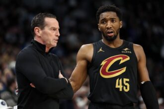 Minneapolis, Minnesota, USA; Cleveland Cavaliers guard Donovan Mitchell (45) talks with head coach Kenny Atkinson during the second quarter against the Minnesota Timberwolves at Target Center. Mandatory Credit: Matt Krohn-Imagn Images